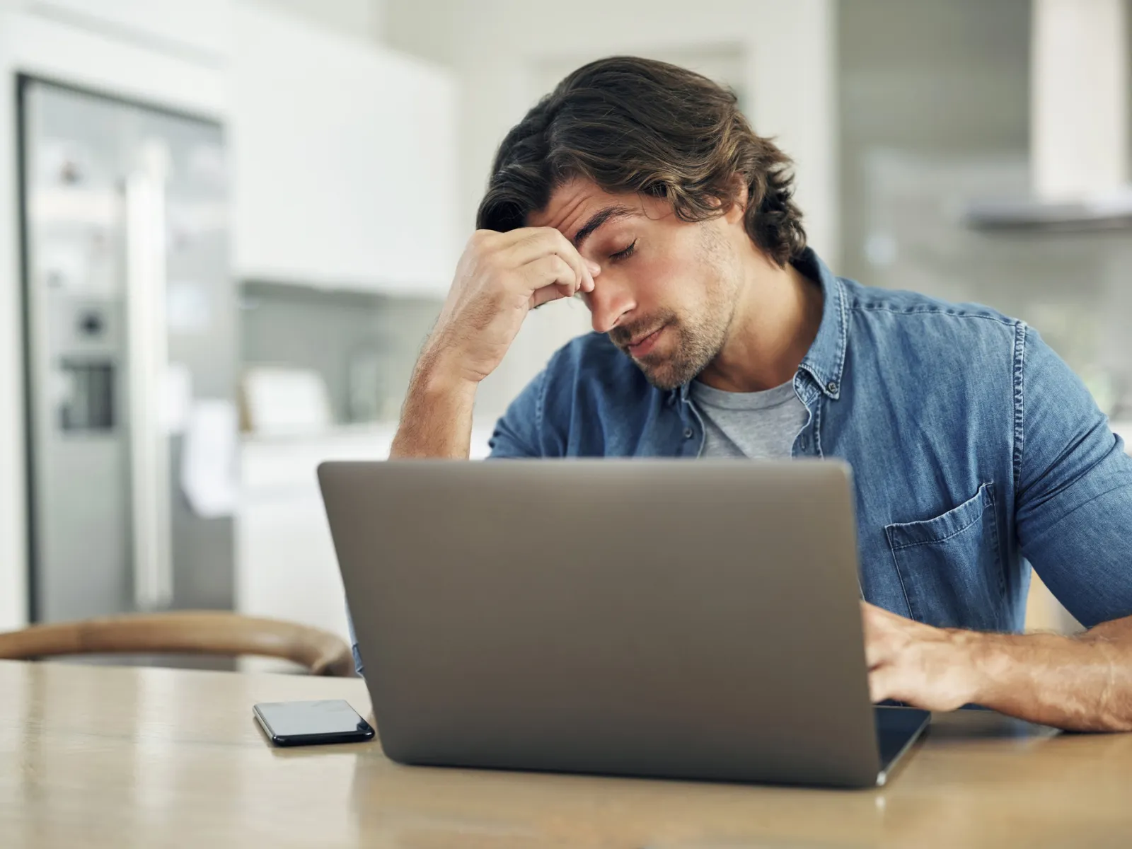 a man looking at a laptop