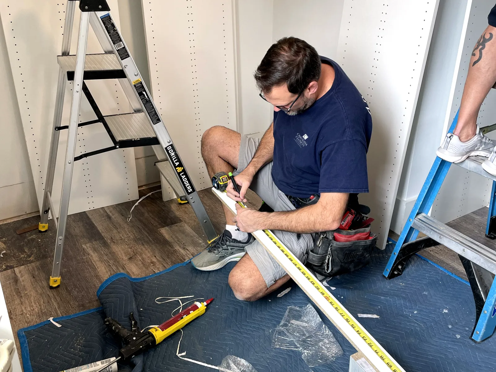 a man painting a blue canvas
