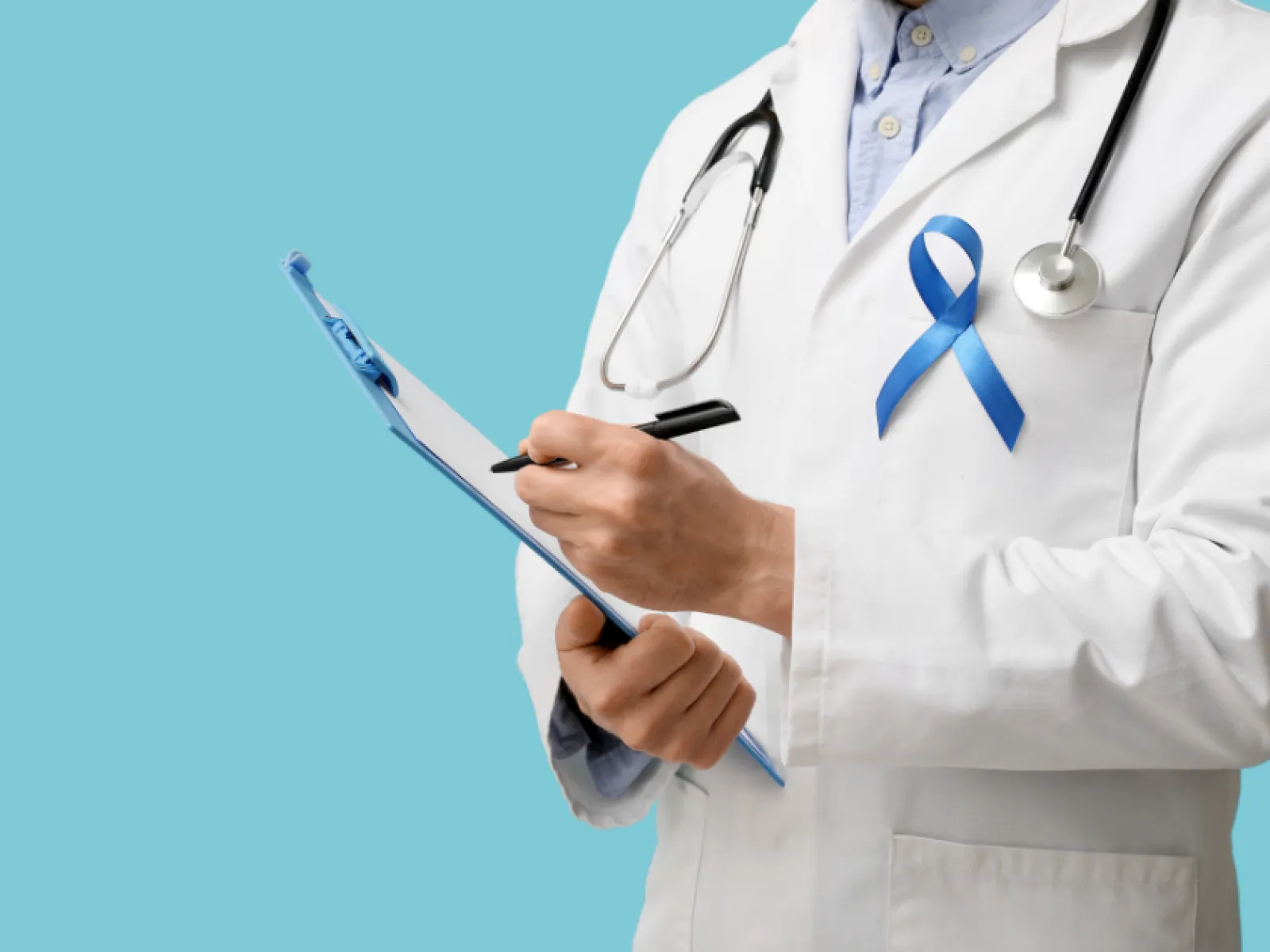 Doctor wearing a stethoscope and blue awareness ribbon writing on a clipboard against a blue background