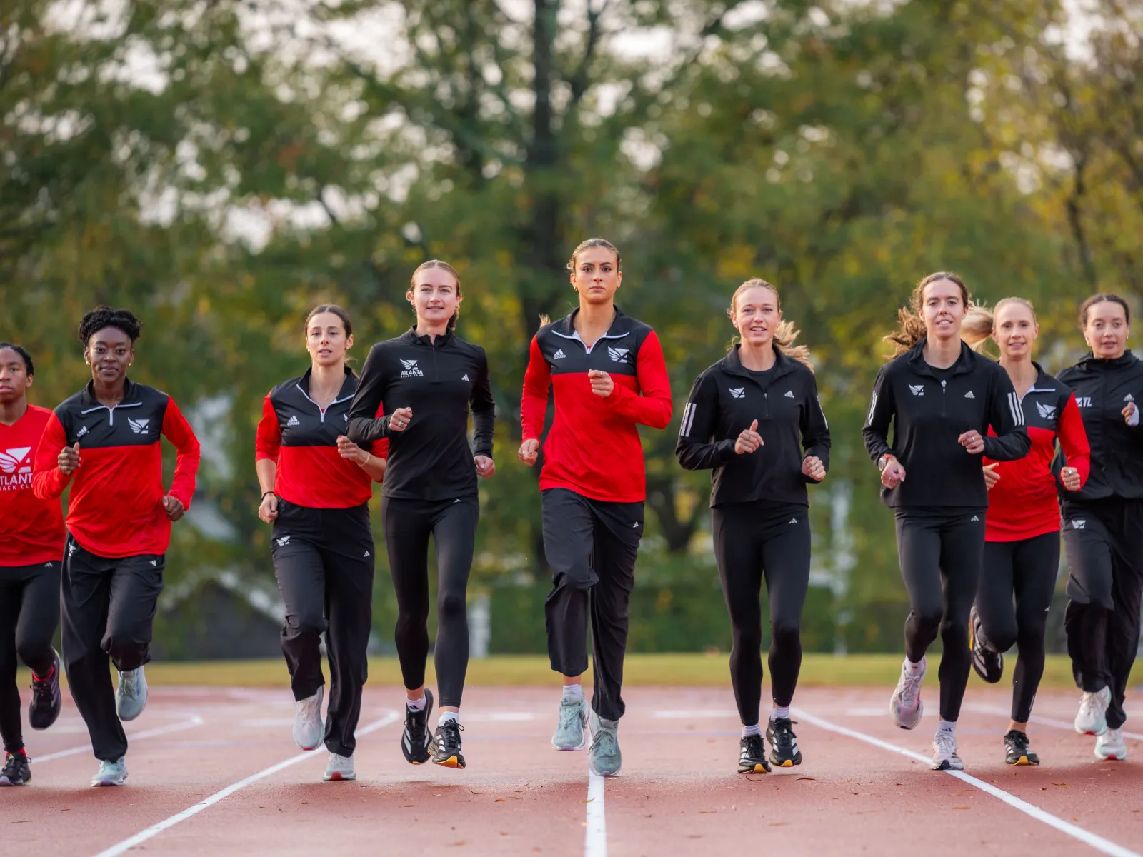 a group of people running on a track