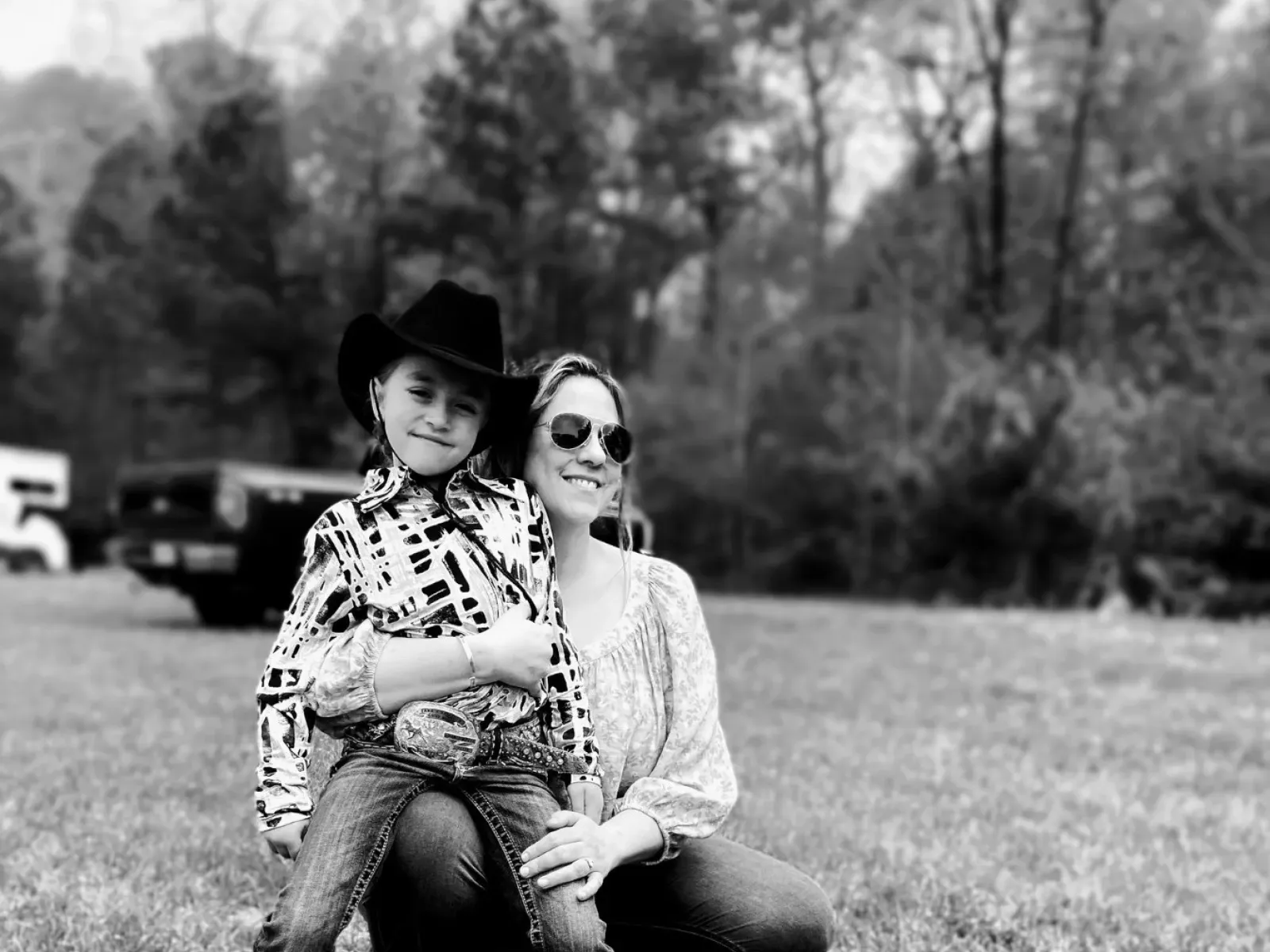 a man and woman sitting on grass