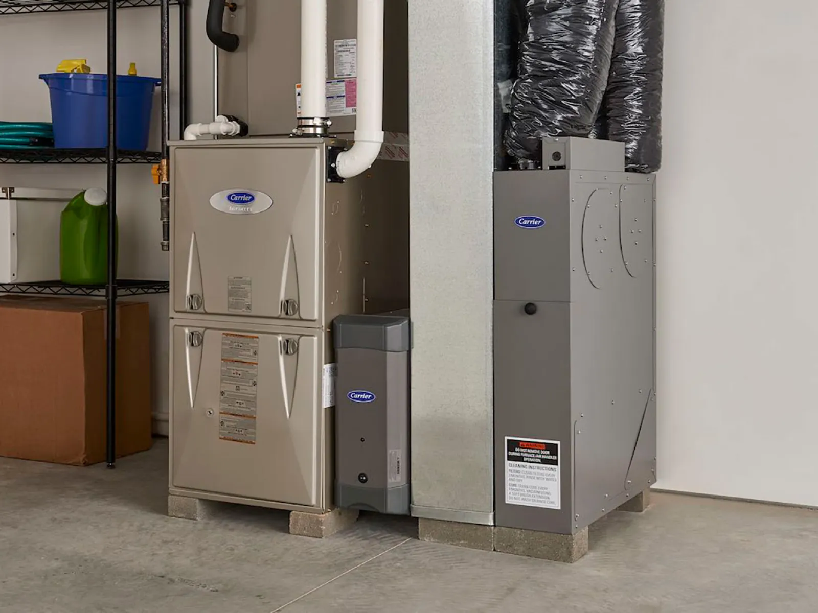 Modern furnace and water heater installation in a clean, organized garage setting.