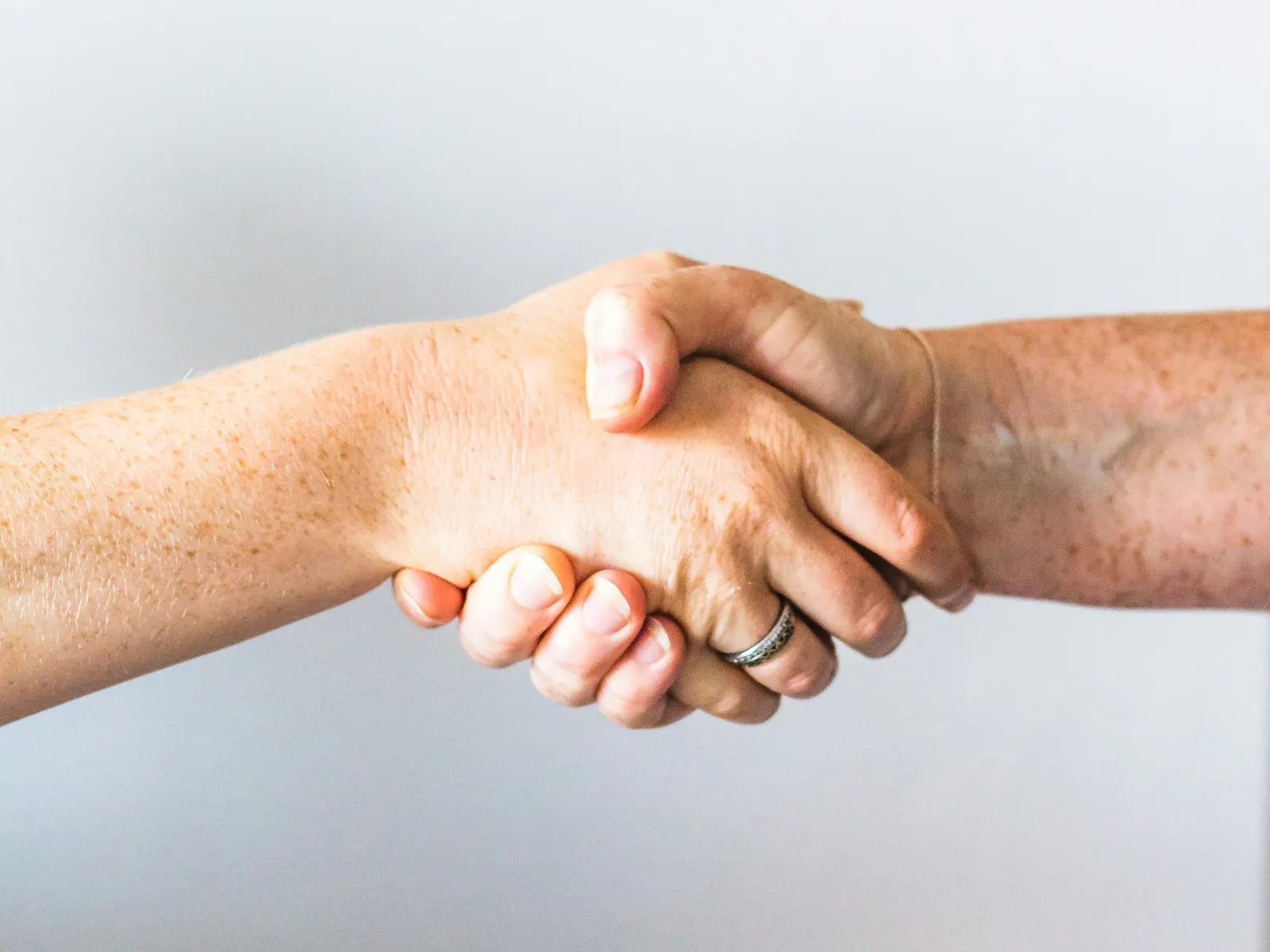 a close-up of hands shaking