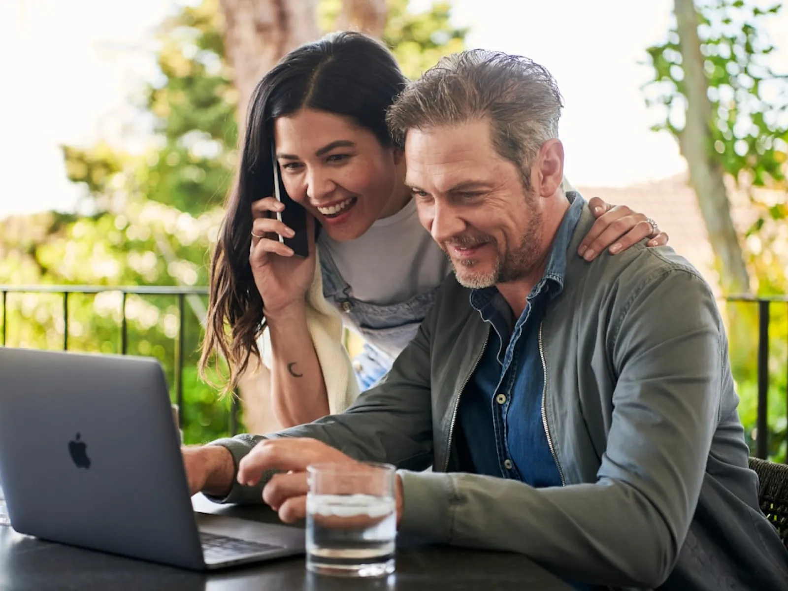 a man and a woman looking at a laptop