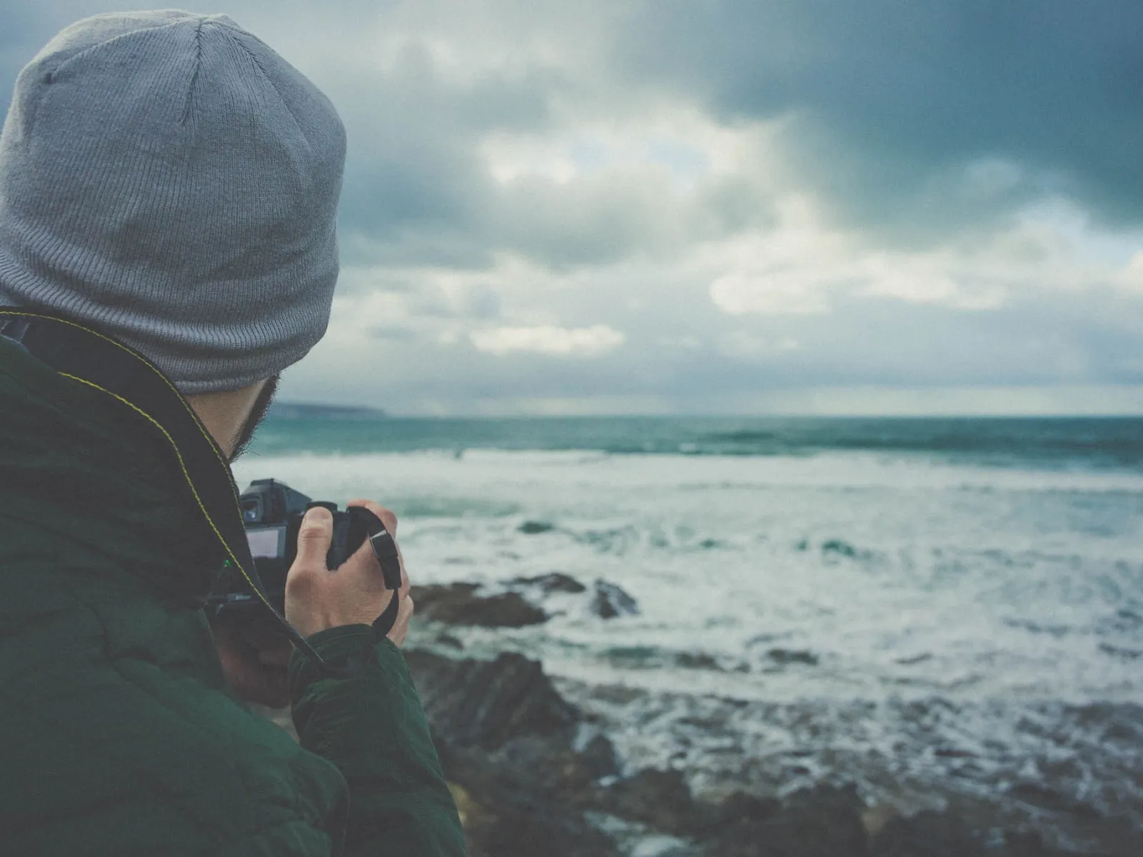 a person taking a picture of the ocean