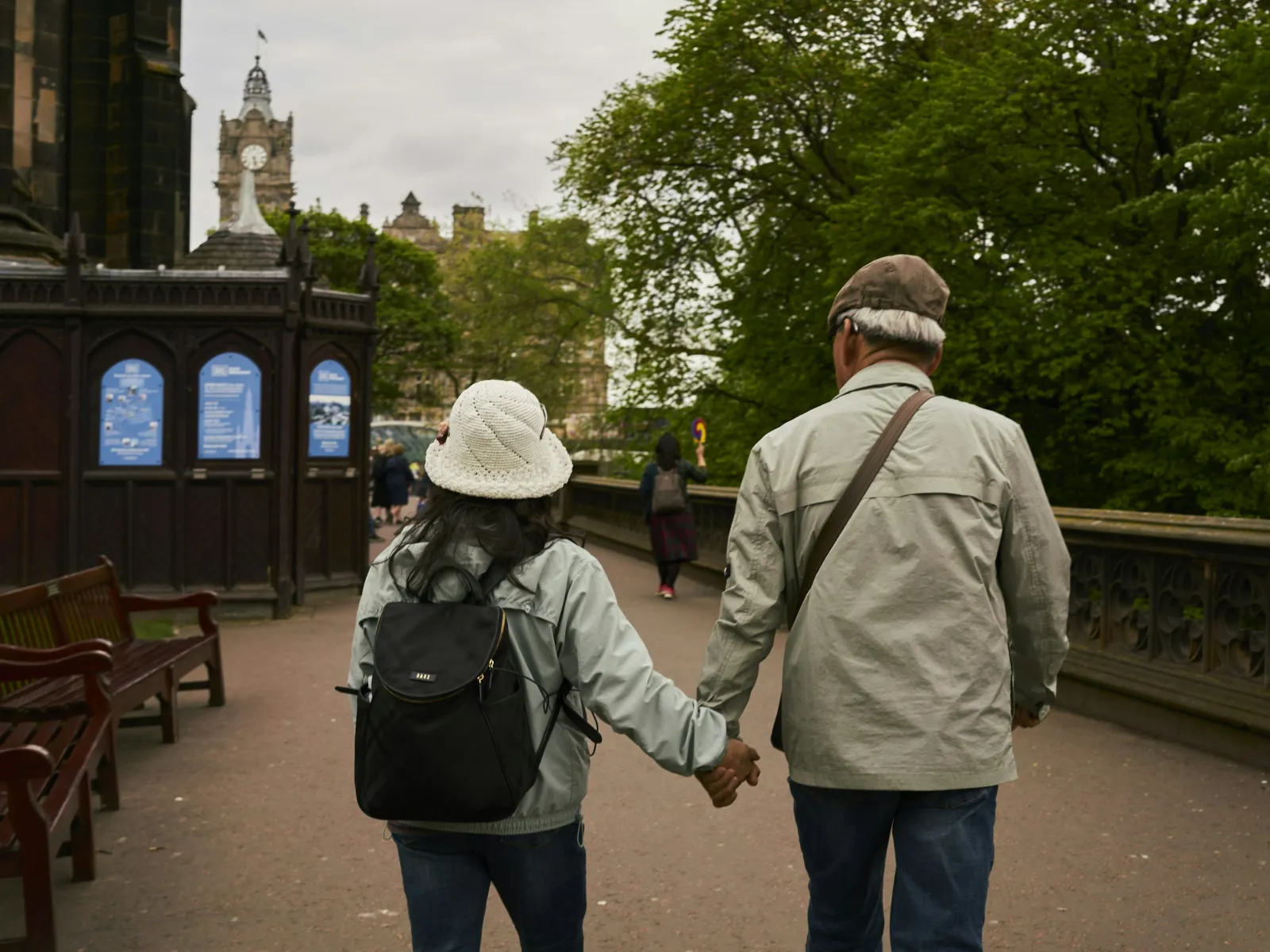 a man and woman walking on a sidewalk