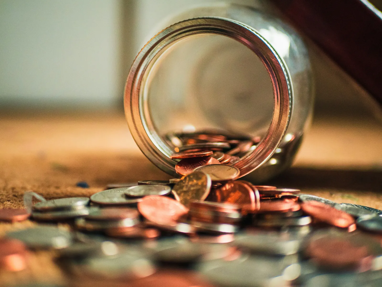 a glass jar filled with coins