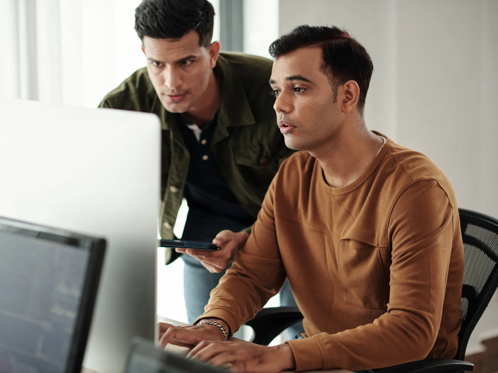 a few business people looking at a computer screen