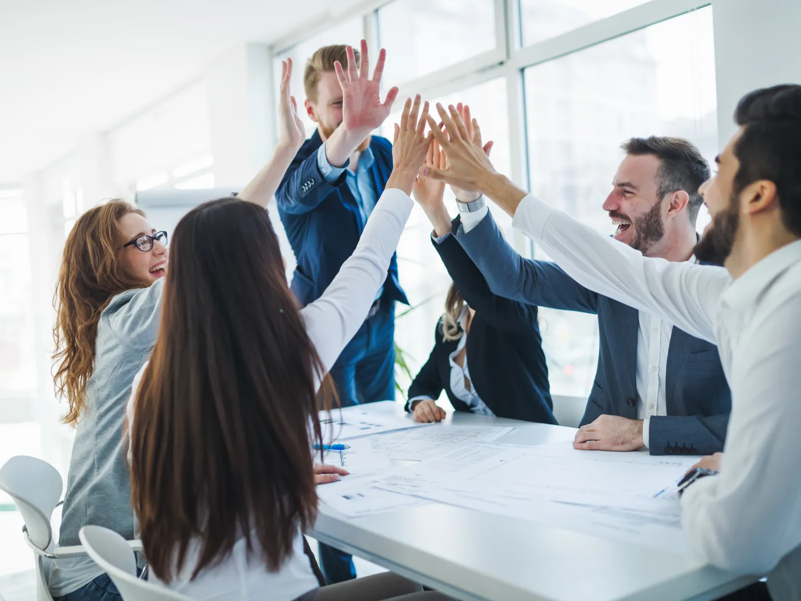 a group of people raising their hands