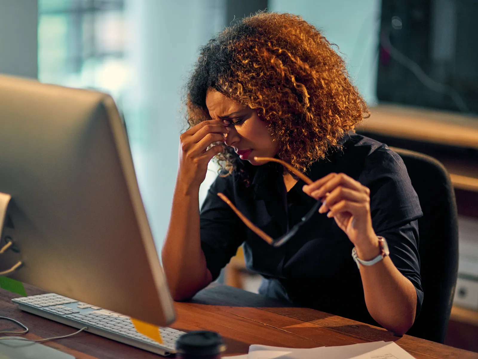 a person sitting at a desk with a laptop