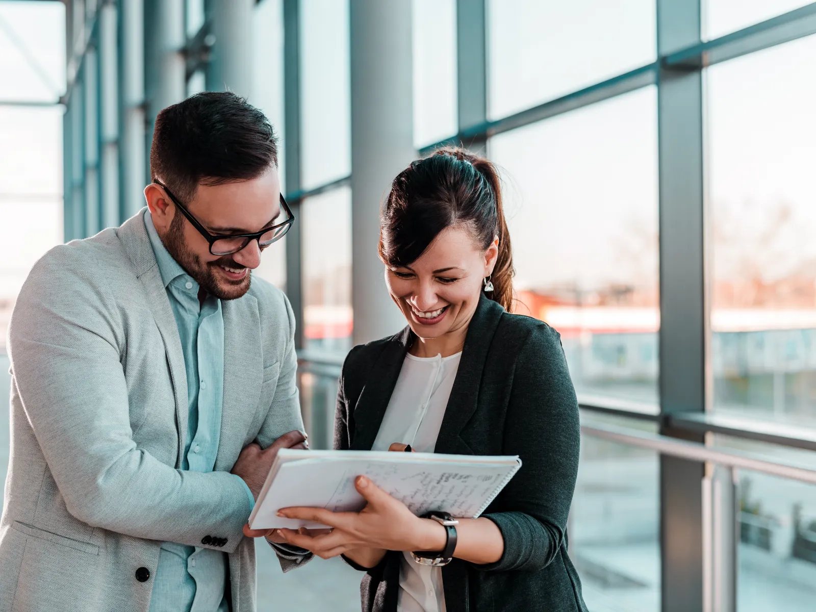 a man and a woman looking at a book