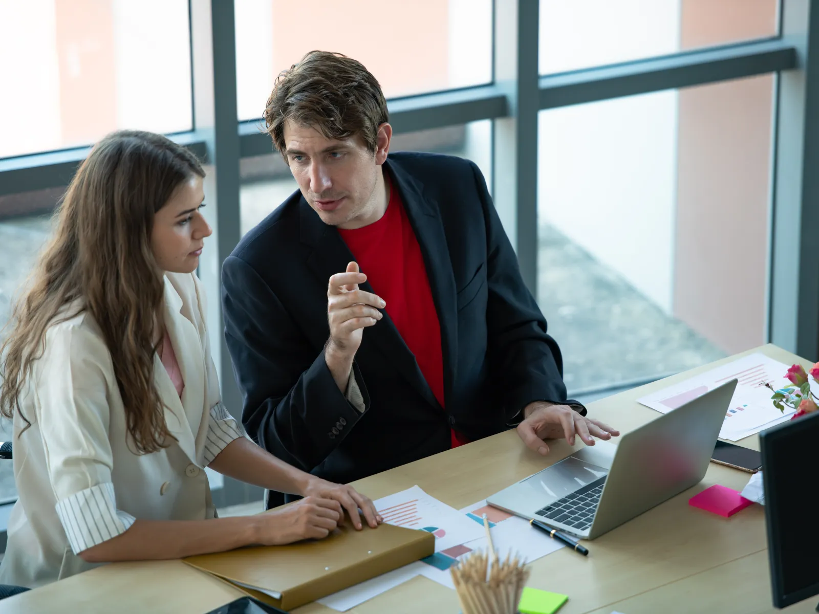 a man and a woman looking at a laptop