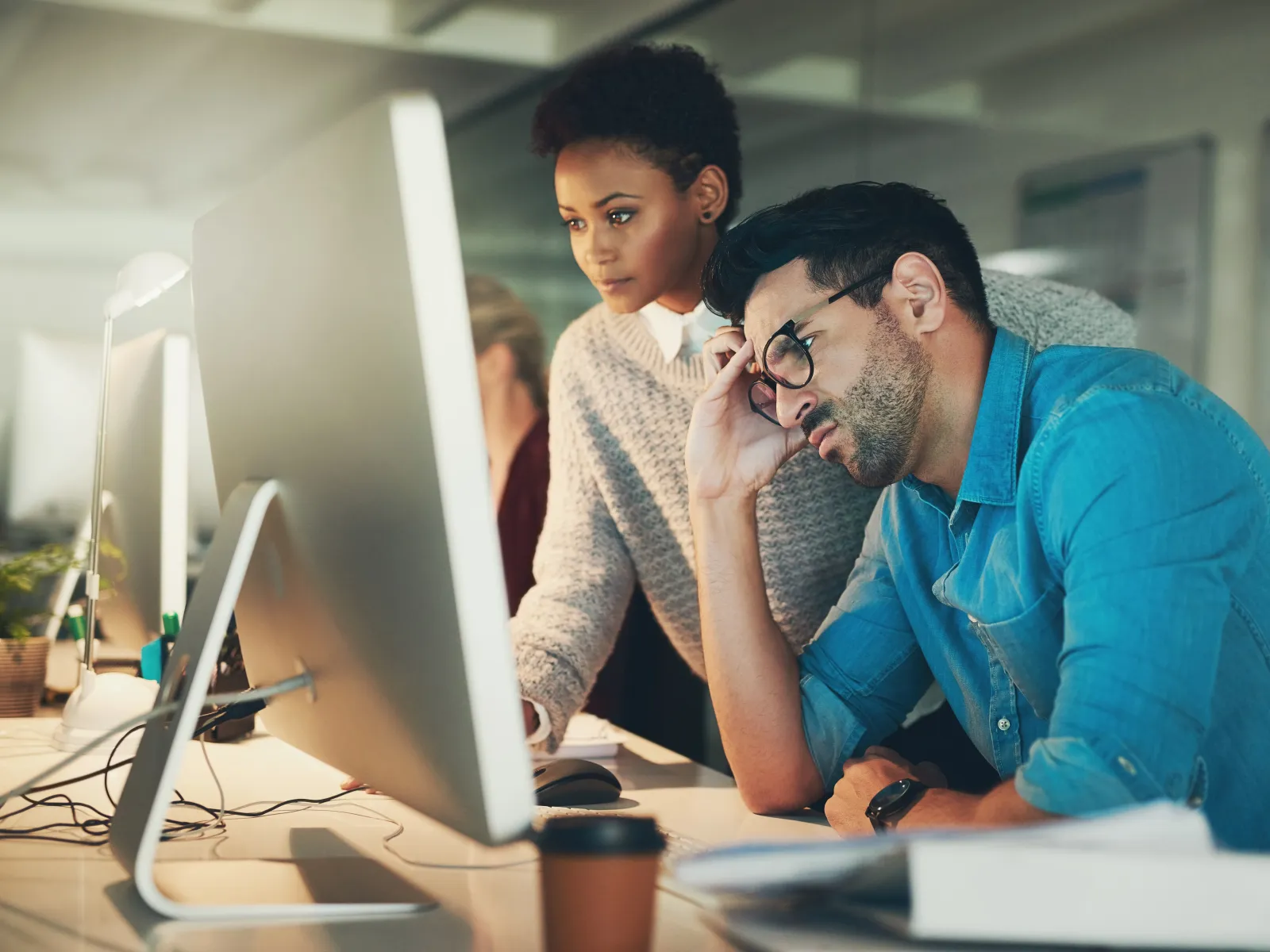 a man and a woman looking at a computer screen