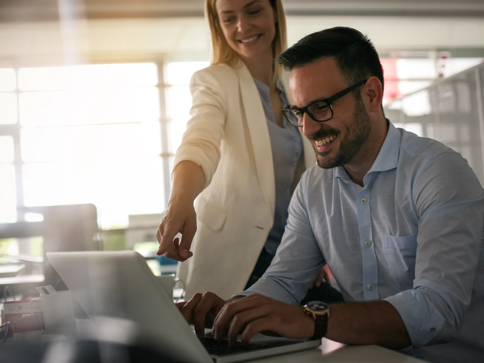 a man and a woman looking at a laptop