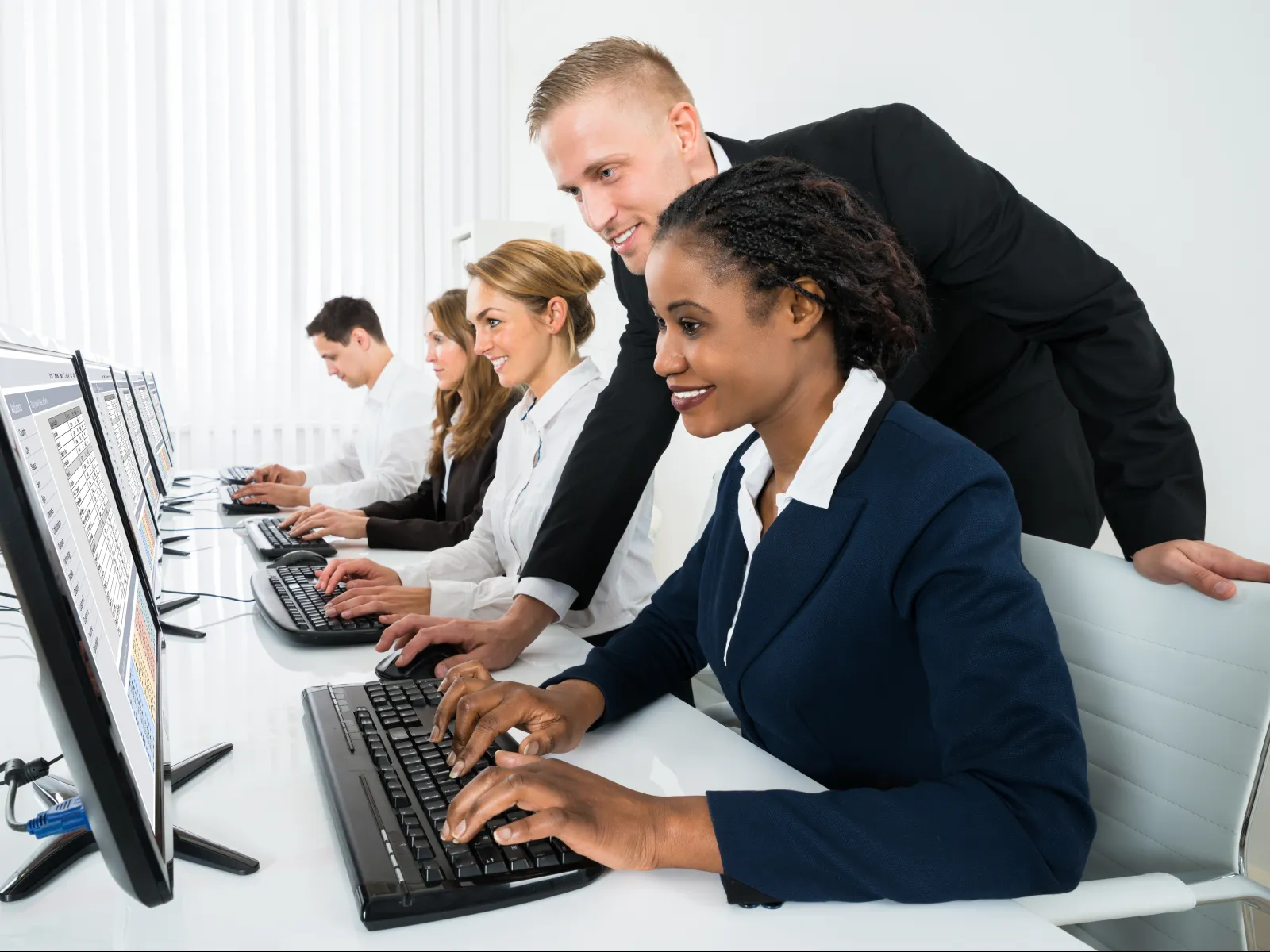 a group of people looking at a computer screen