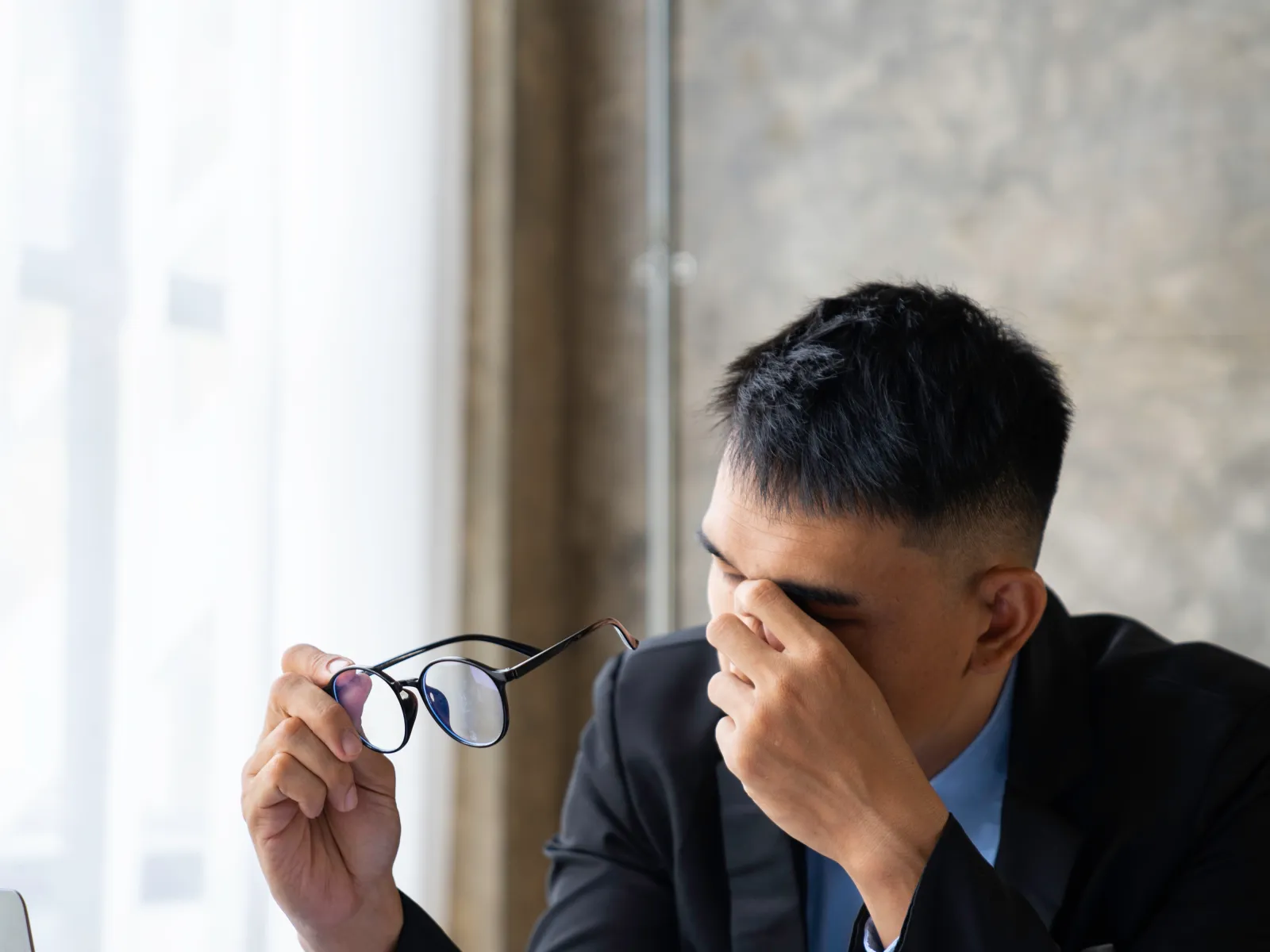 a person sitting at a table with the hand on the face