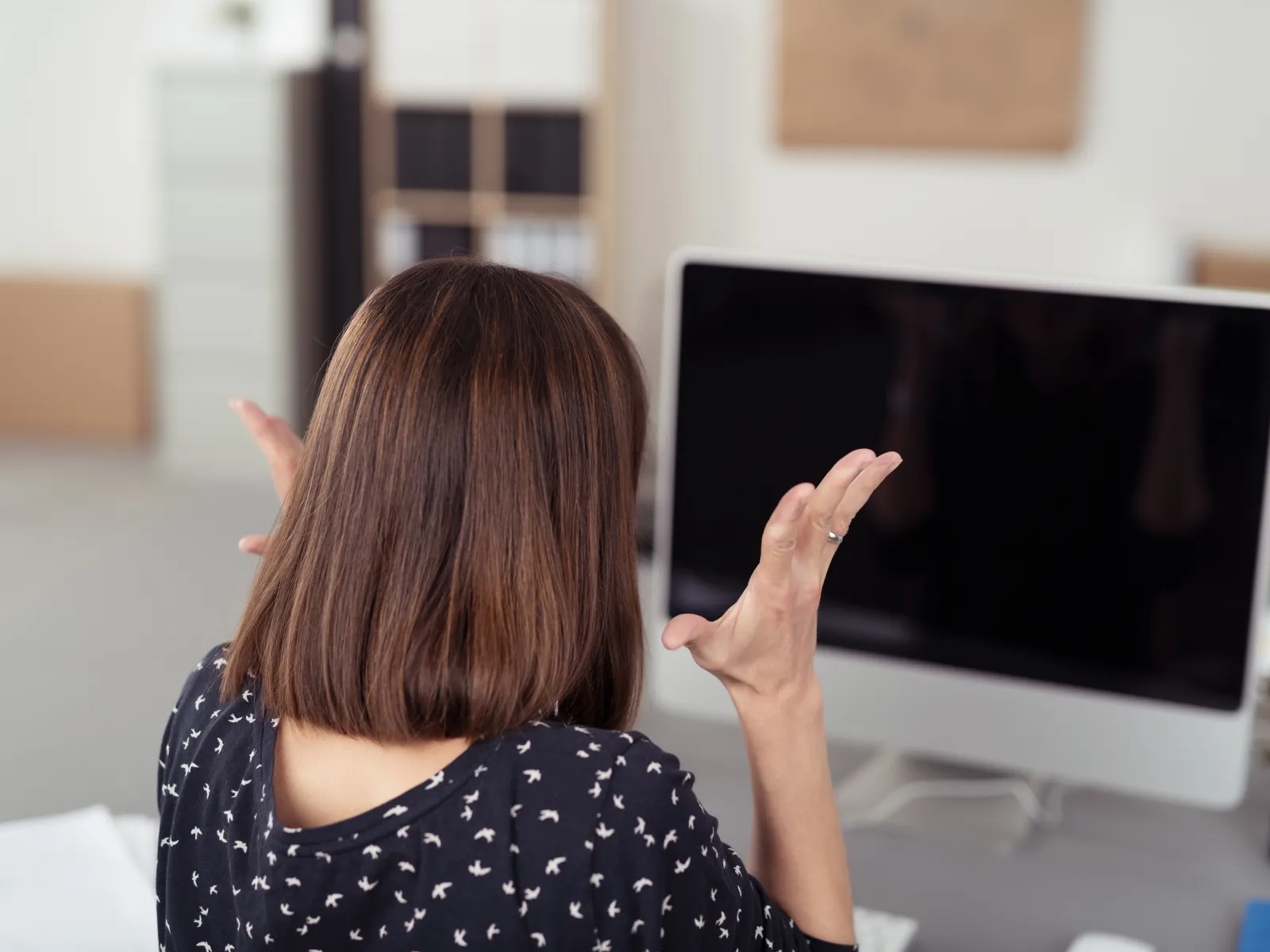 a woman pointing at a screen