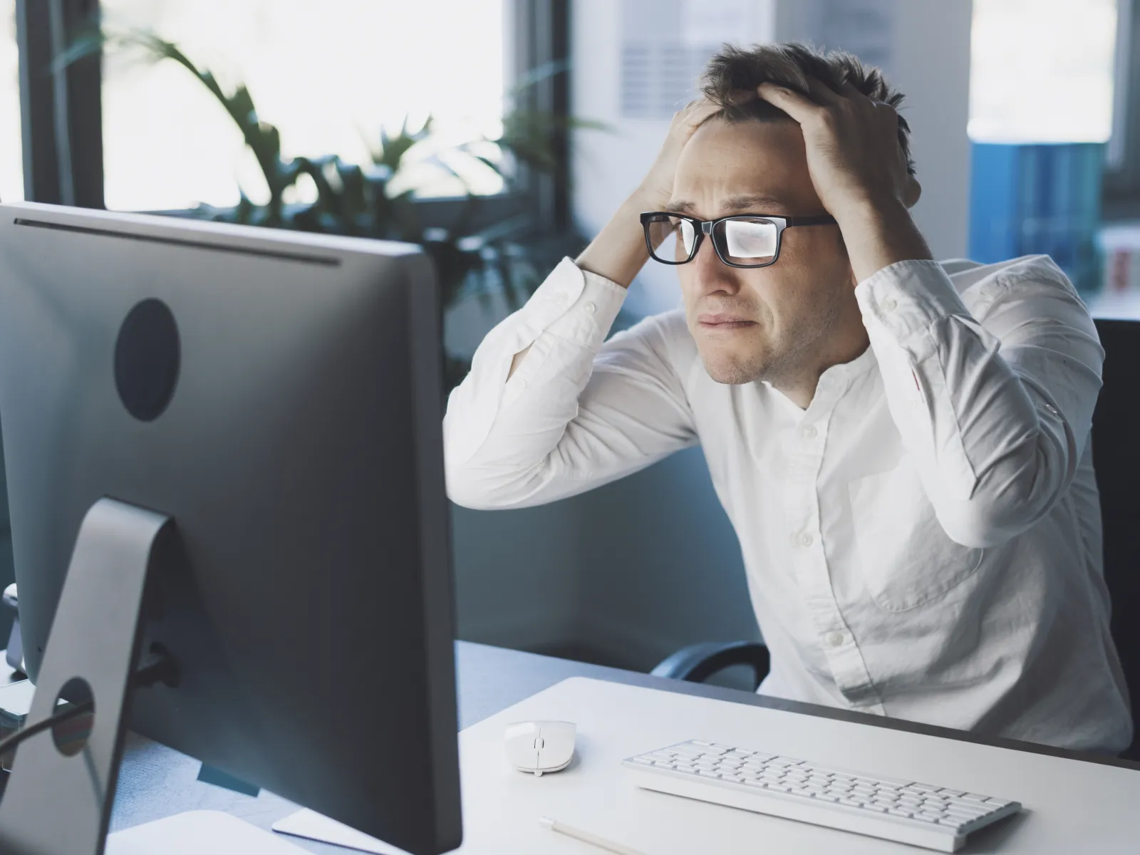 a man sitting at a desk with a computer