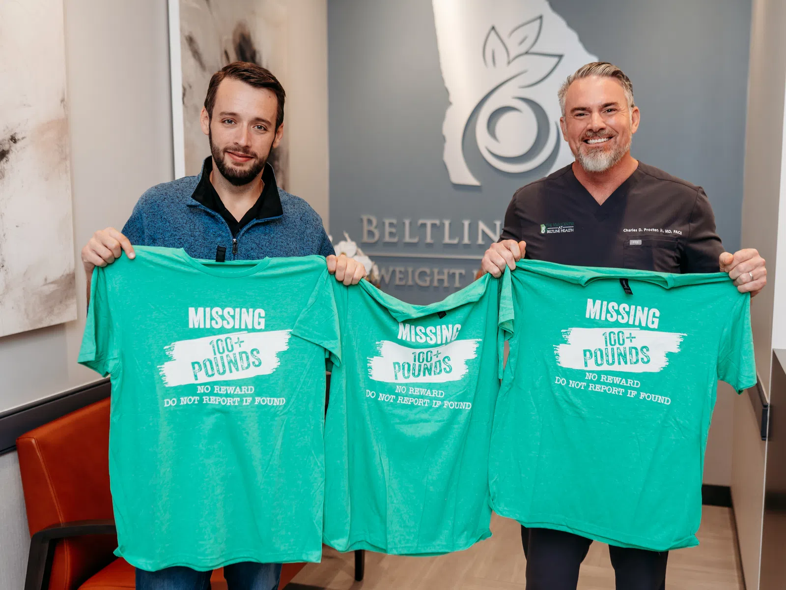 Two men holding green T-shirts with text Missing 100+ pounds promoting weight loss success at a clinic.