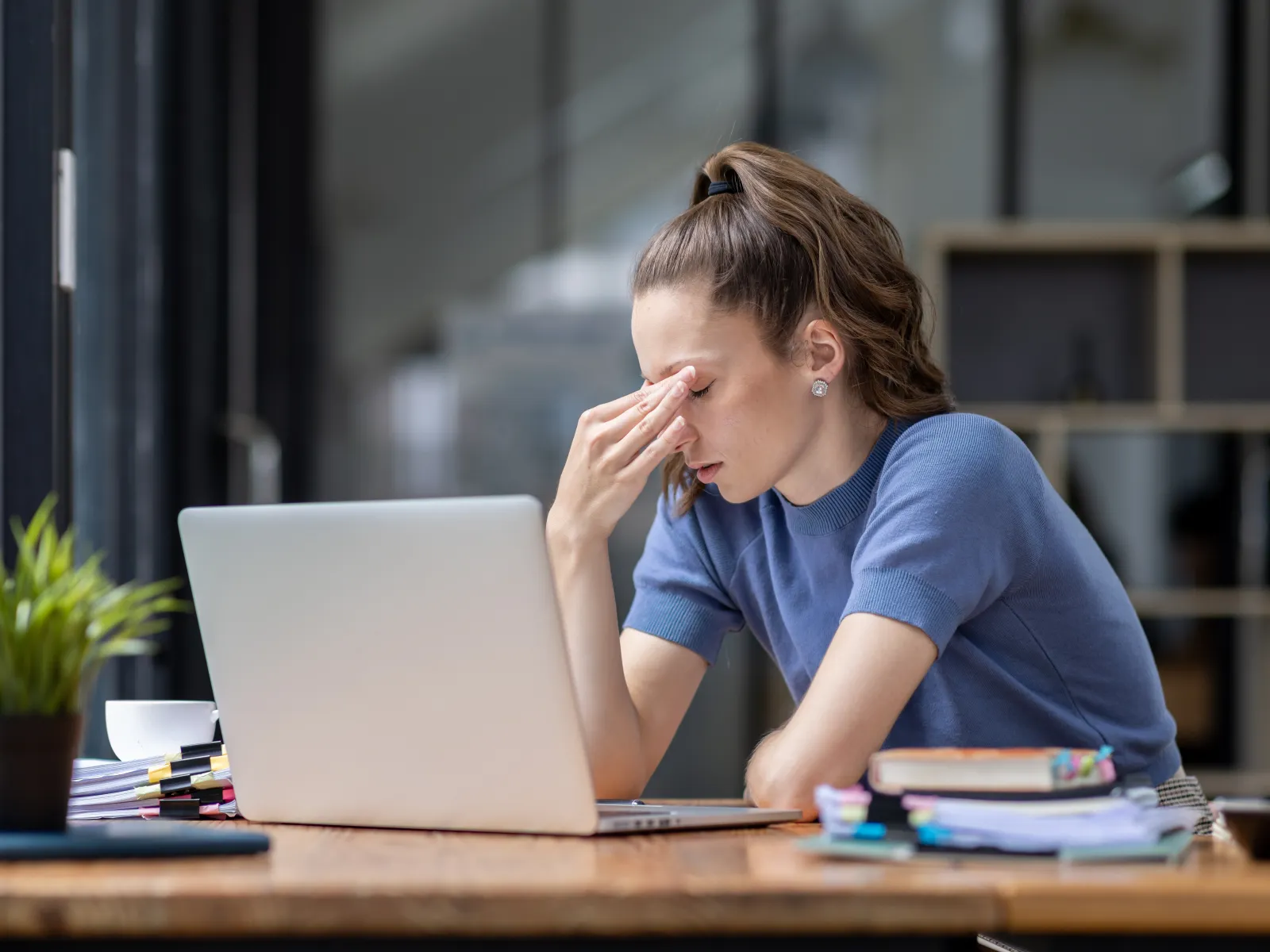 a person sitting at a desk with a laptop