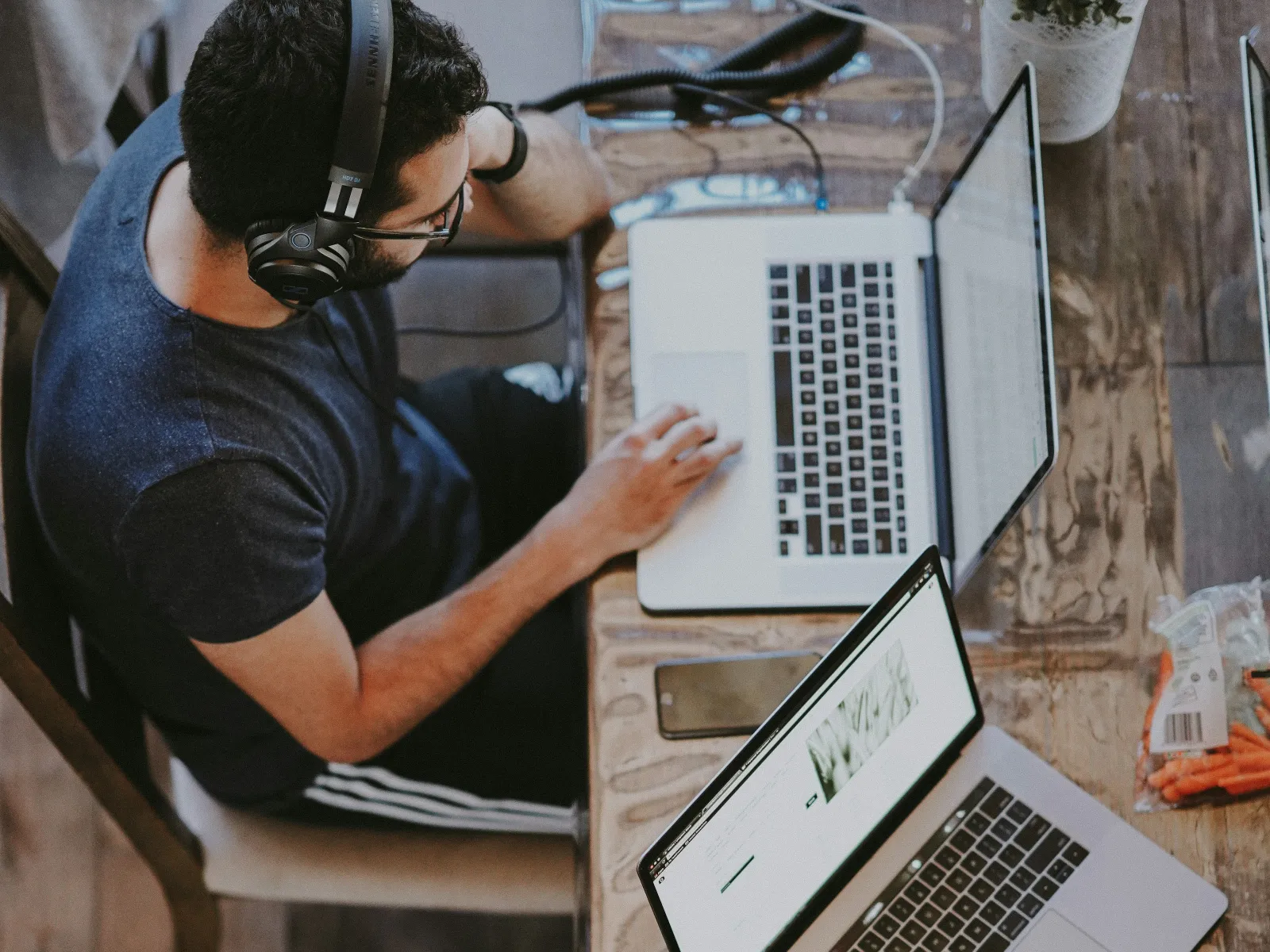 a person wearing headphones and using a laptop