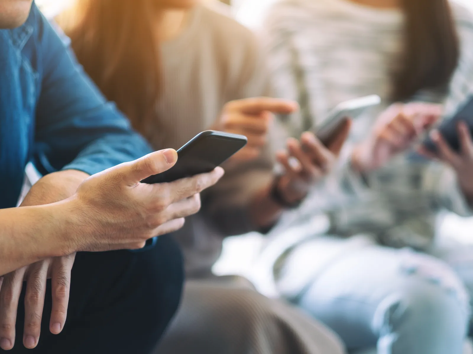 a group of people using their phones