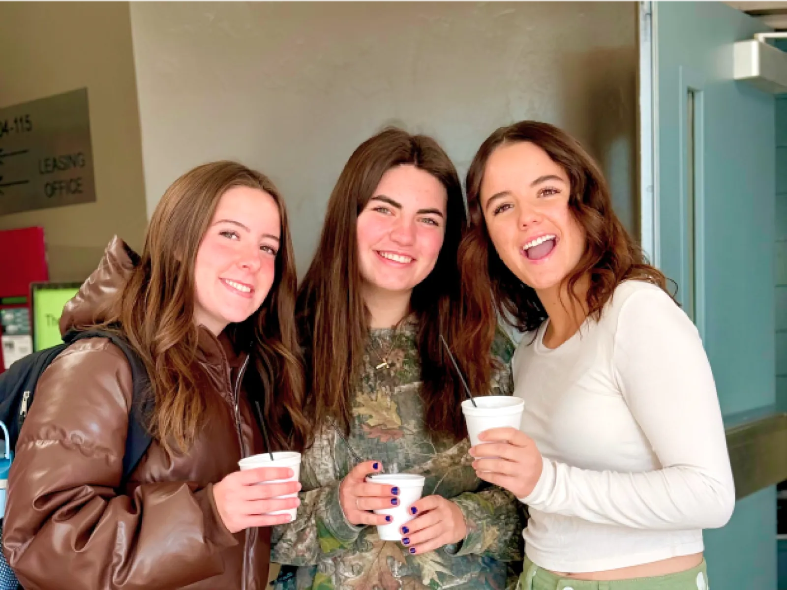 a group of women holding cups