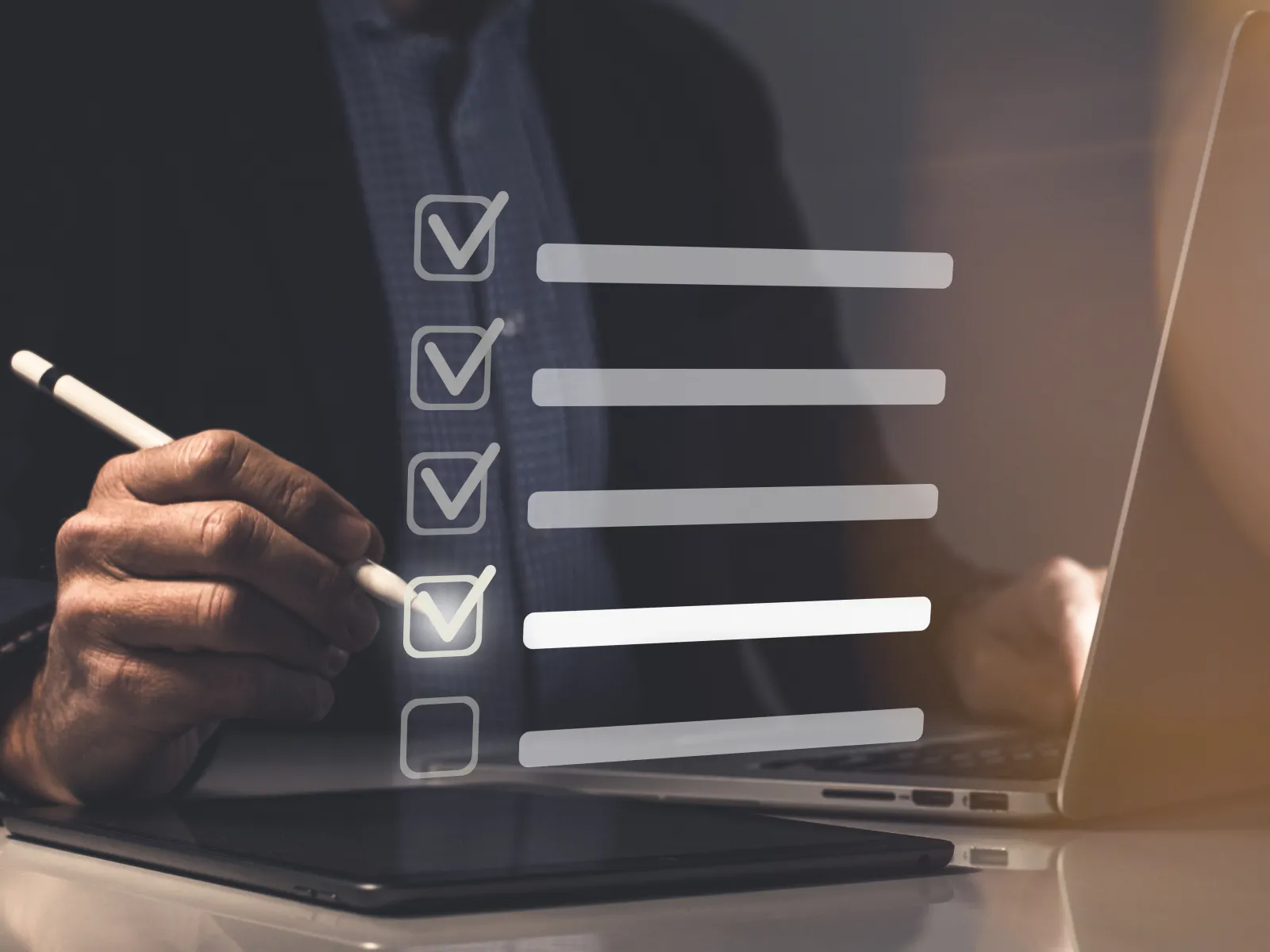 Businessman using digital pen and laptop with virtual checklist and progress bars in office setting.