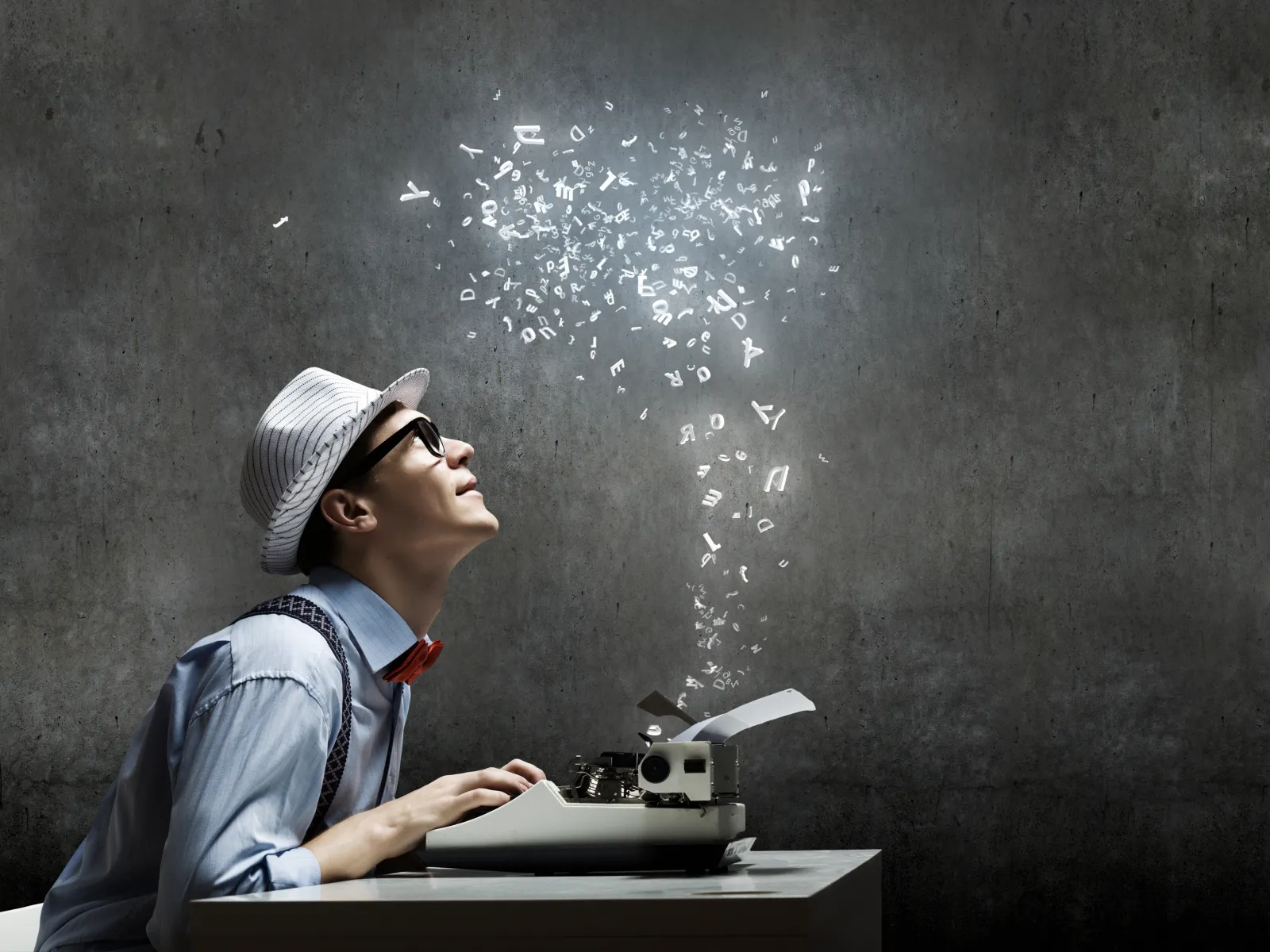 Man wearing a hat and glasses typing on a typewriter with glowing letters rising into the air