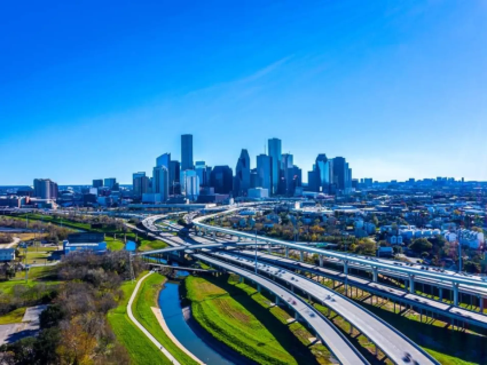 a train on a track with a city in the background
