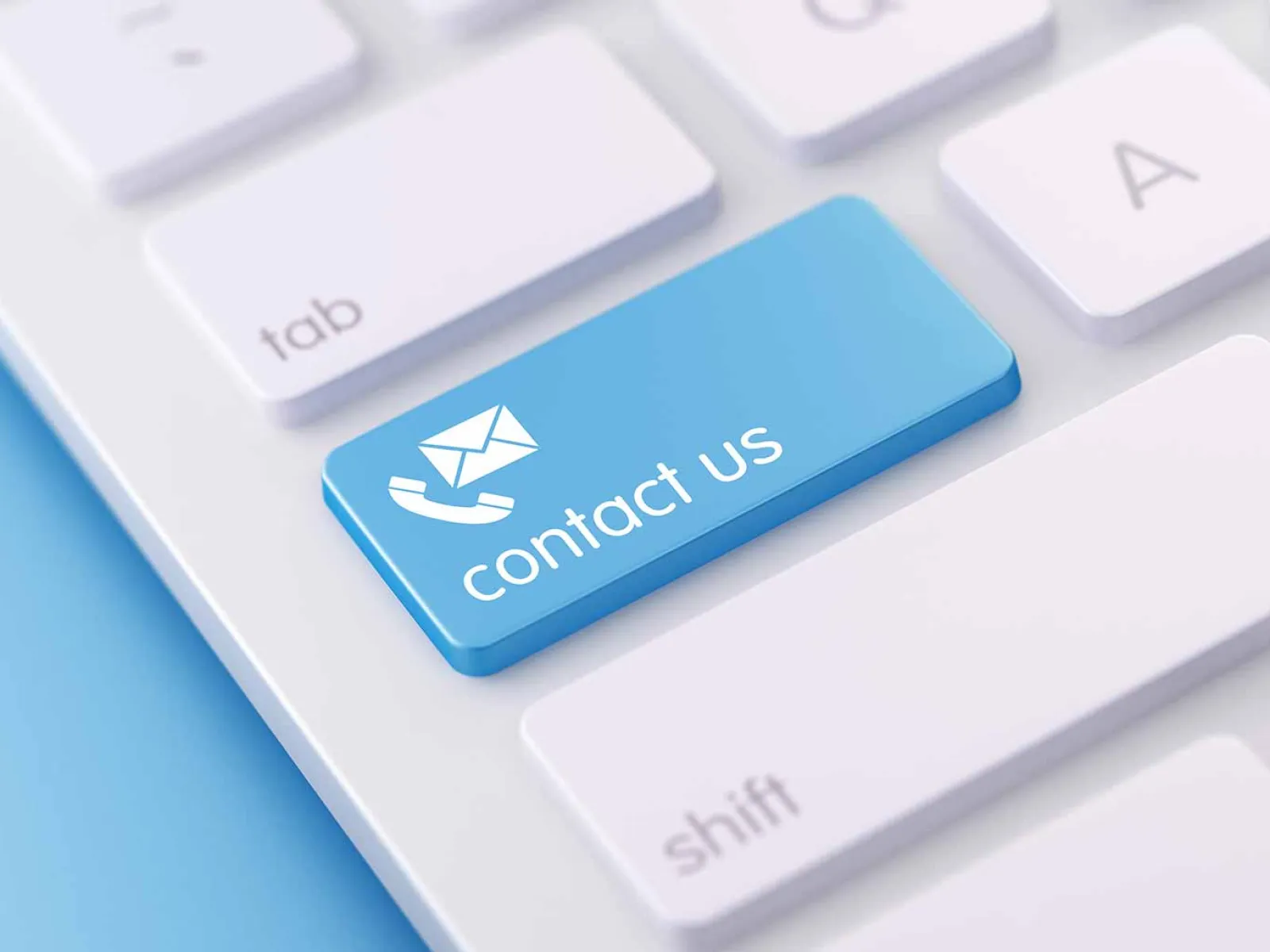 Close-up of a white keyboard with a blue Contact Us key featuring phone and email icons.