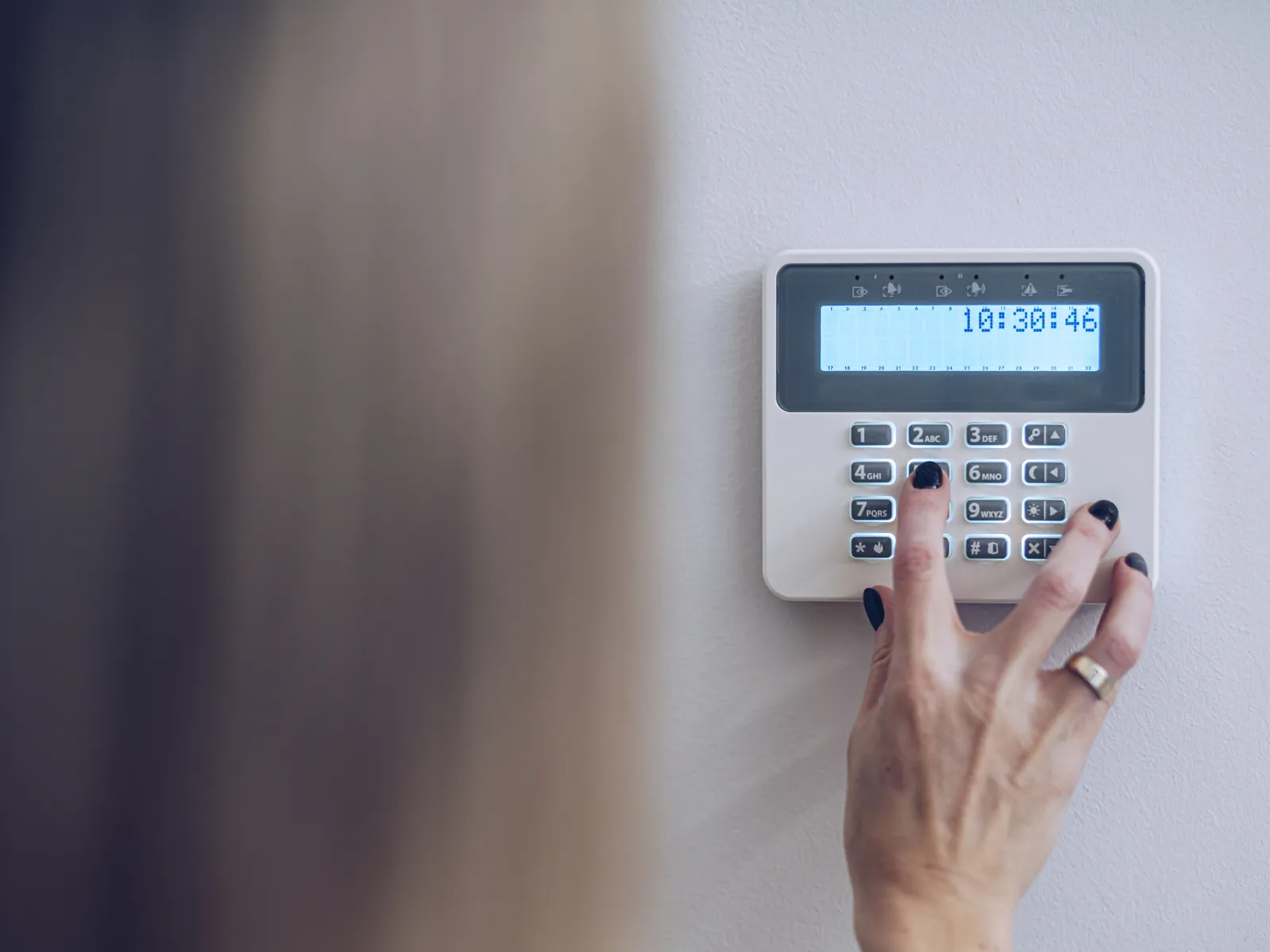 a person using a security system keypad