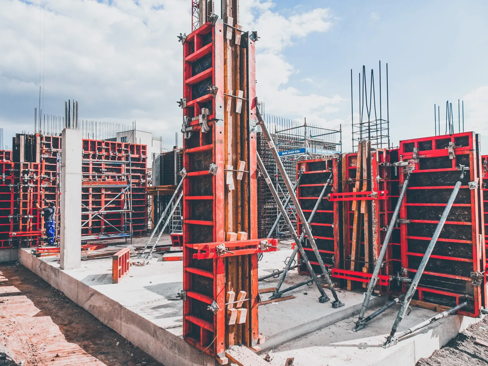 a large red frame structures at large construction site