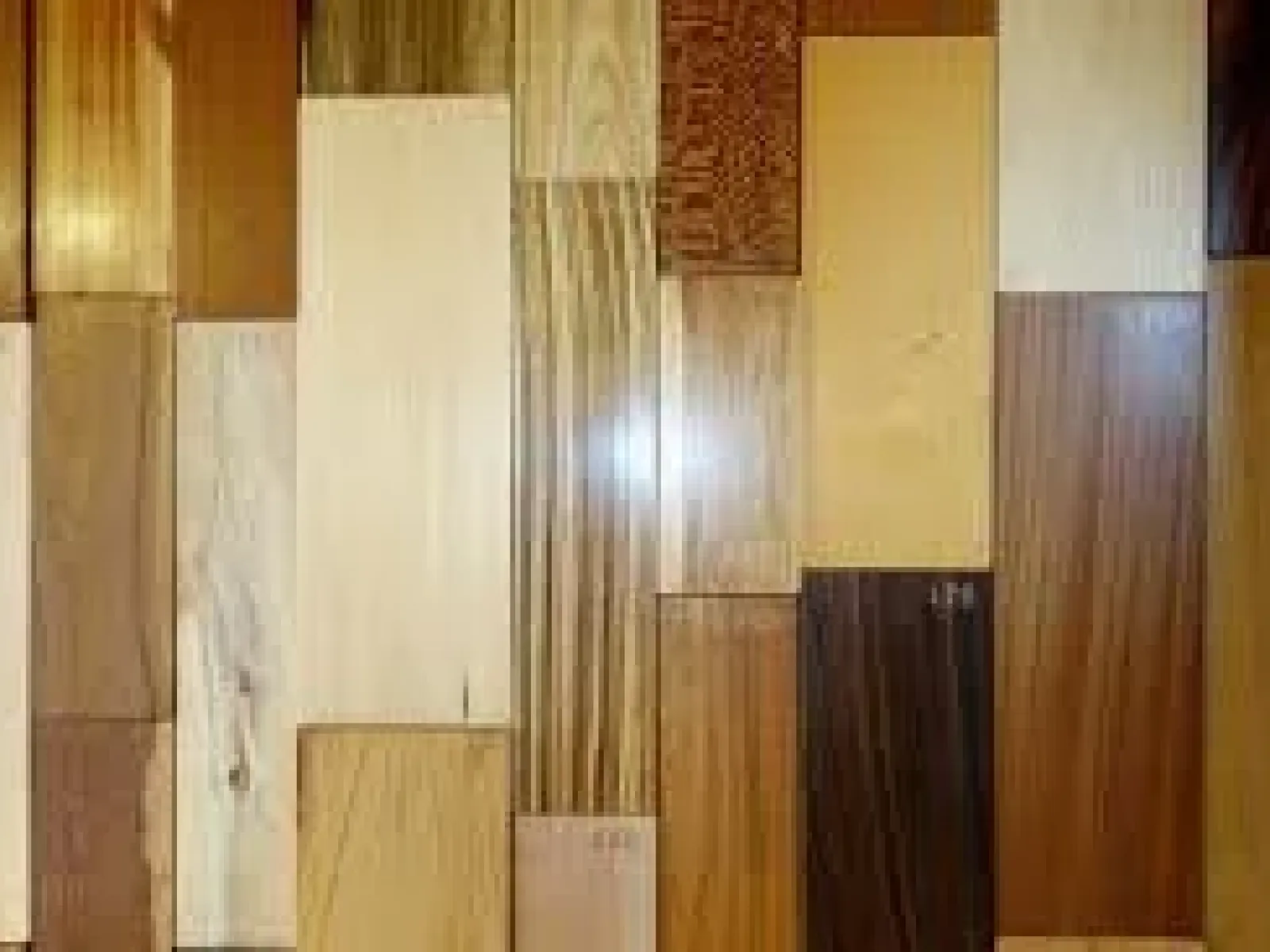 Variety of wooden planks with different grains, colors, and finishes arranged side by side in a grid.