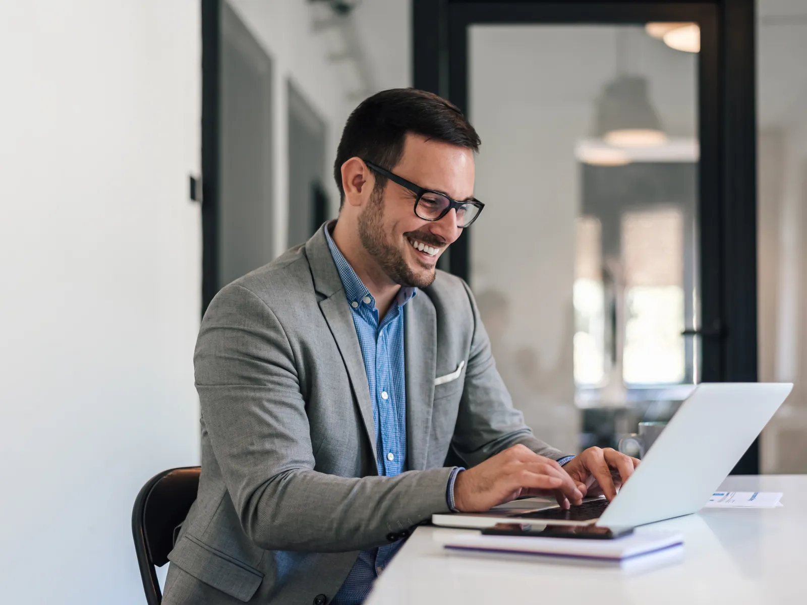 a man sitting at a table with a laptop