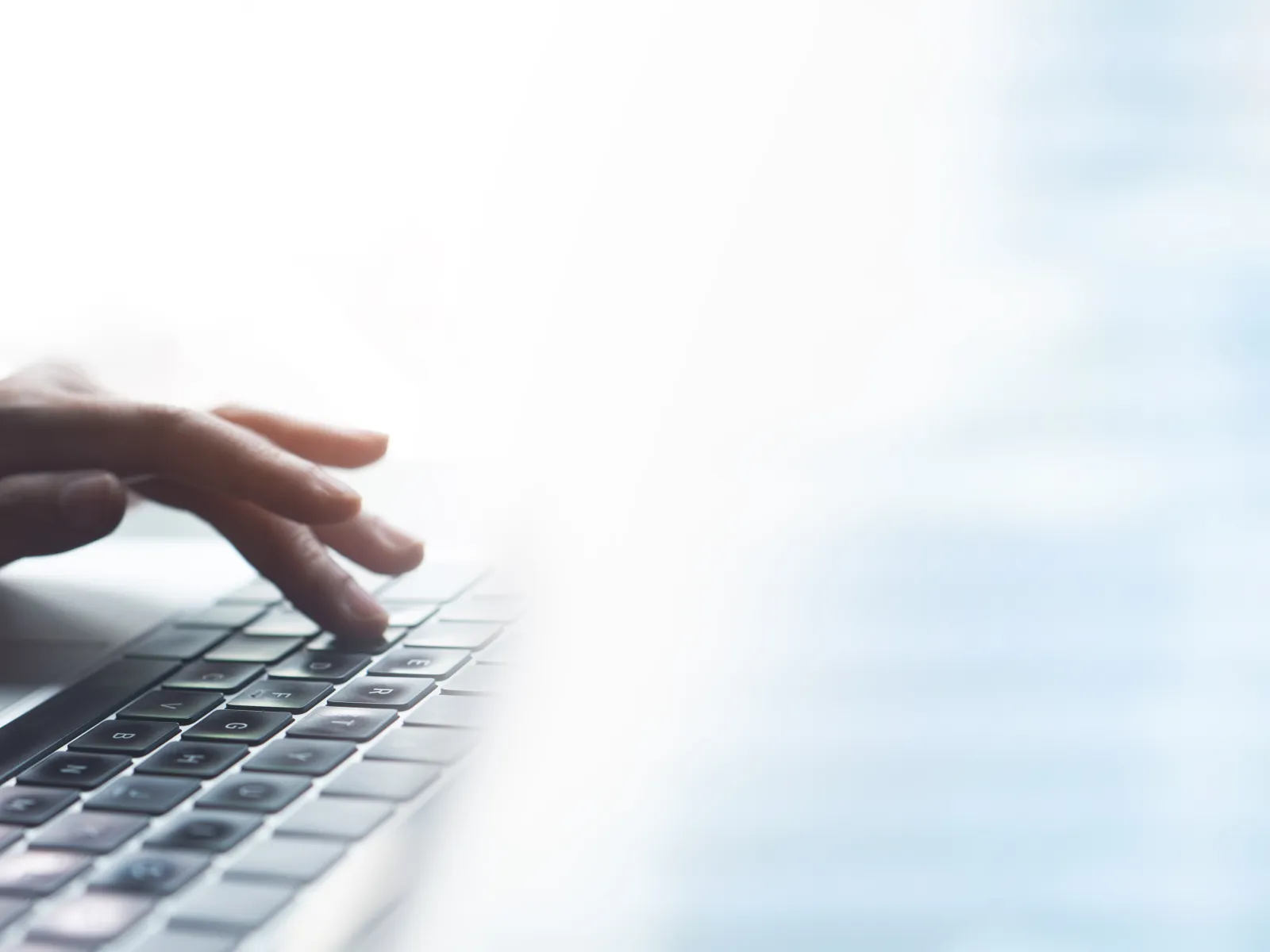 close-up of hands typing on a keyboard