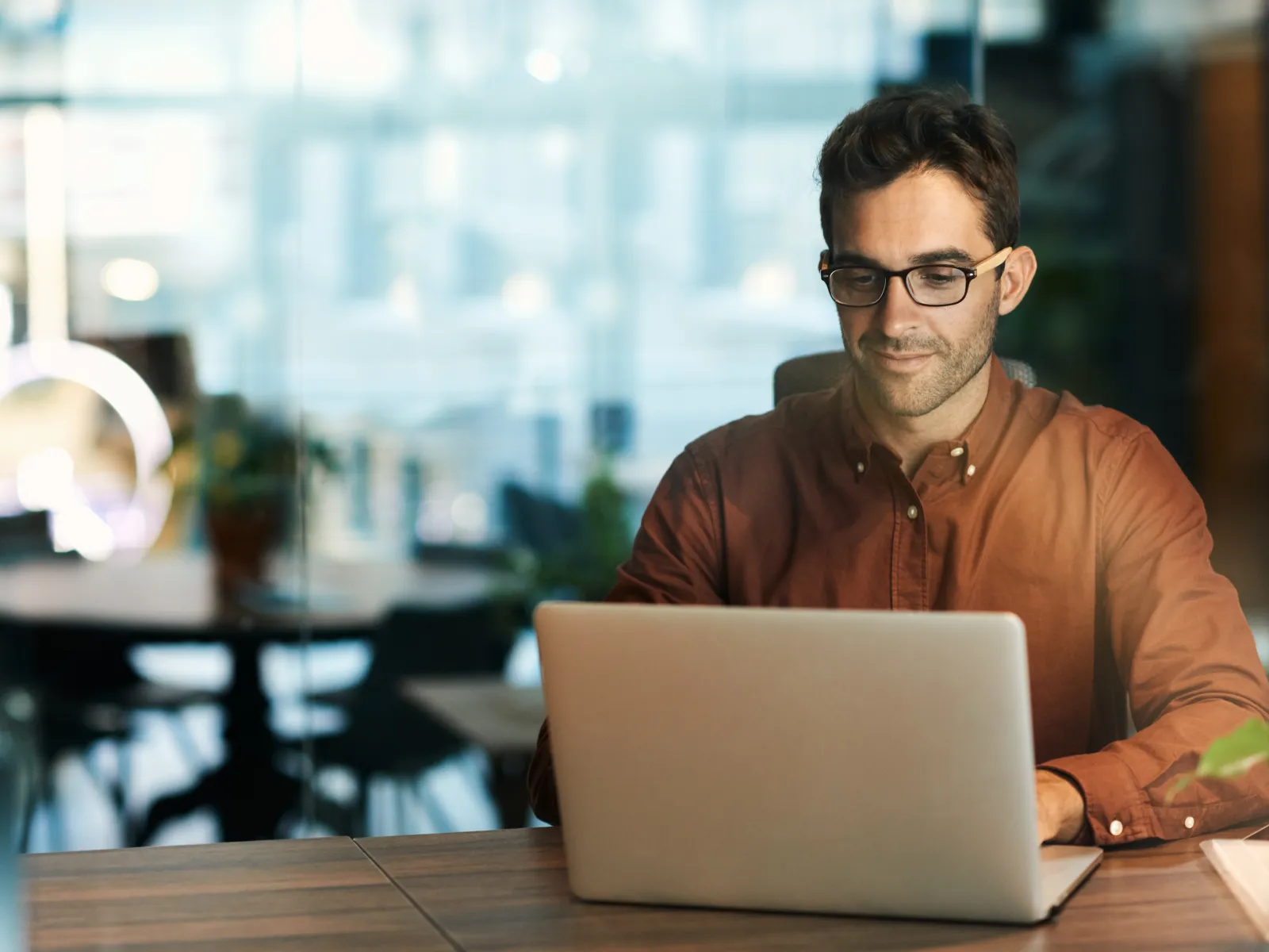 a man sitting at a table with a laptop