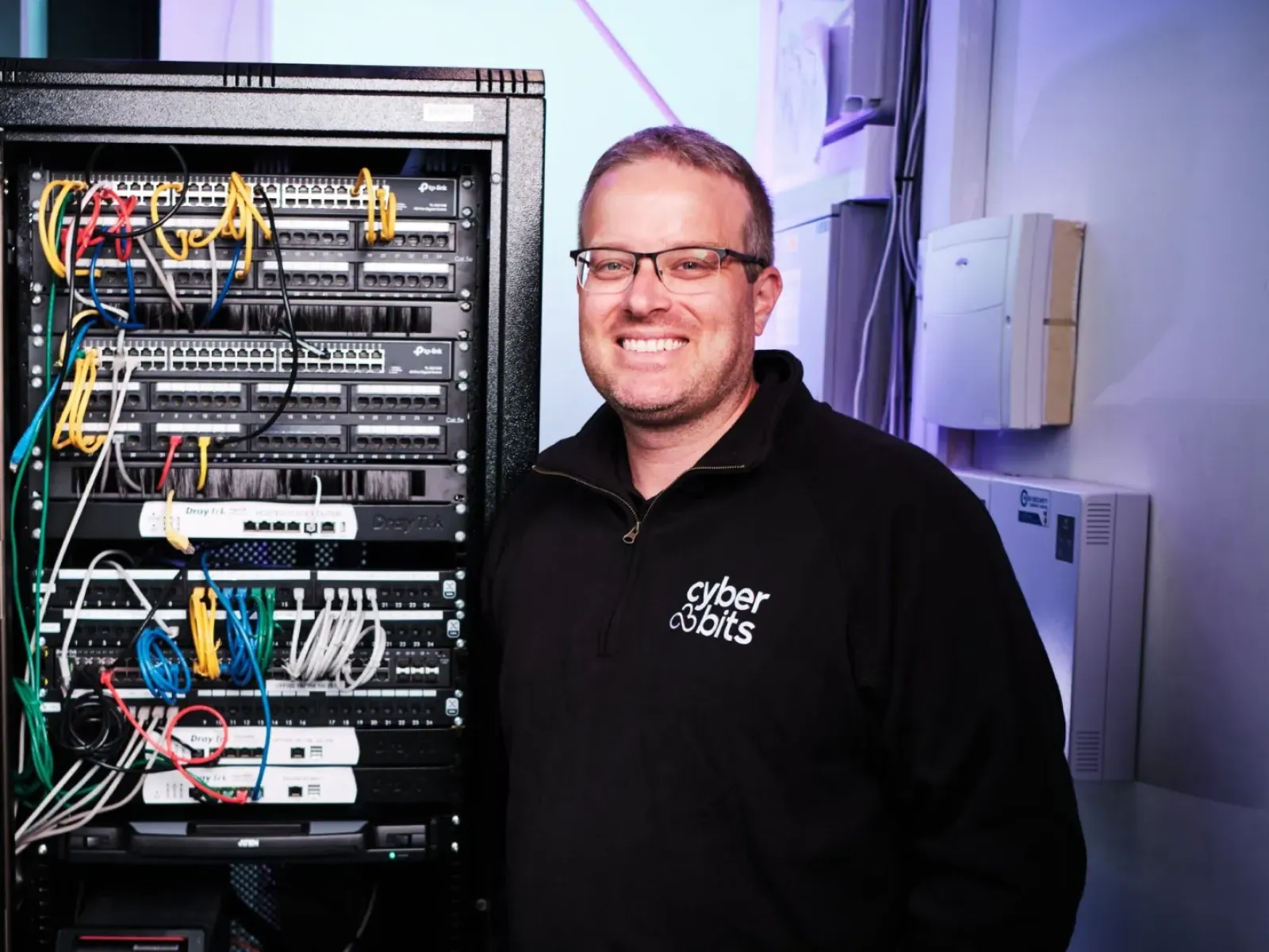 a man standing next to a computer