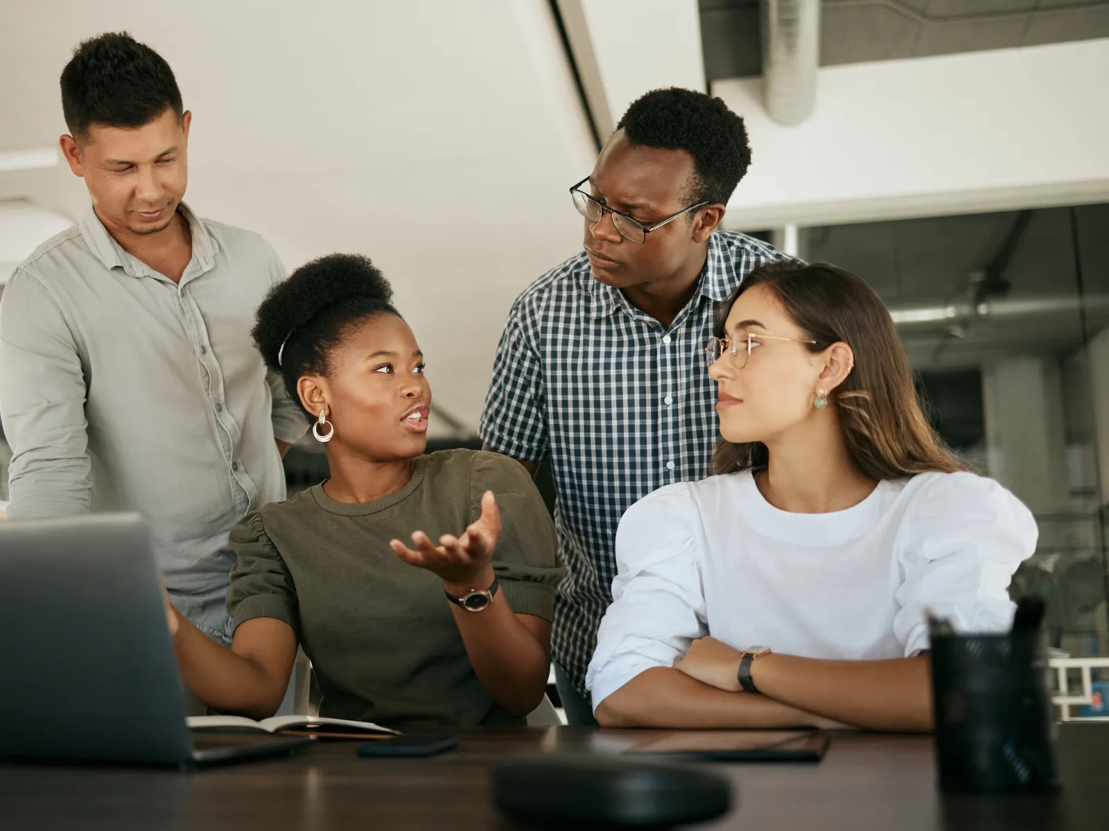 a group of people looking at a laptop
