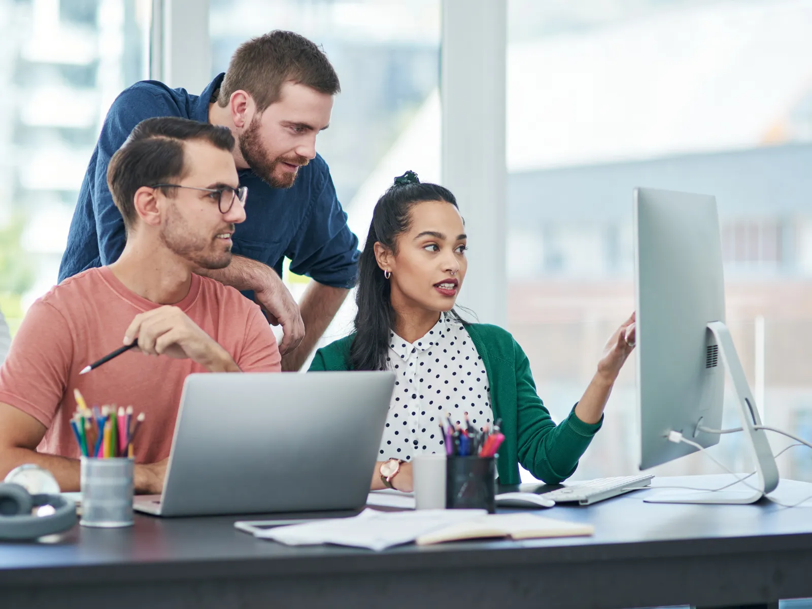 a group of people looking at a computer screen