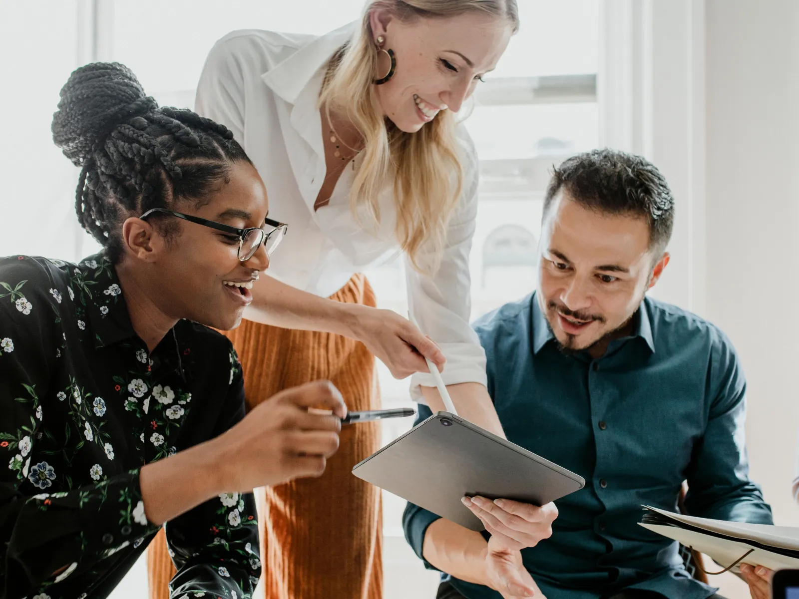 a group of people looking at a paper