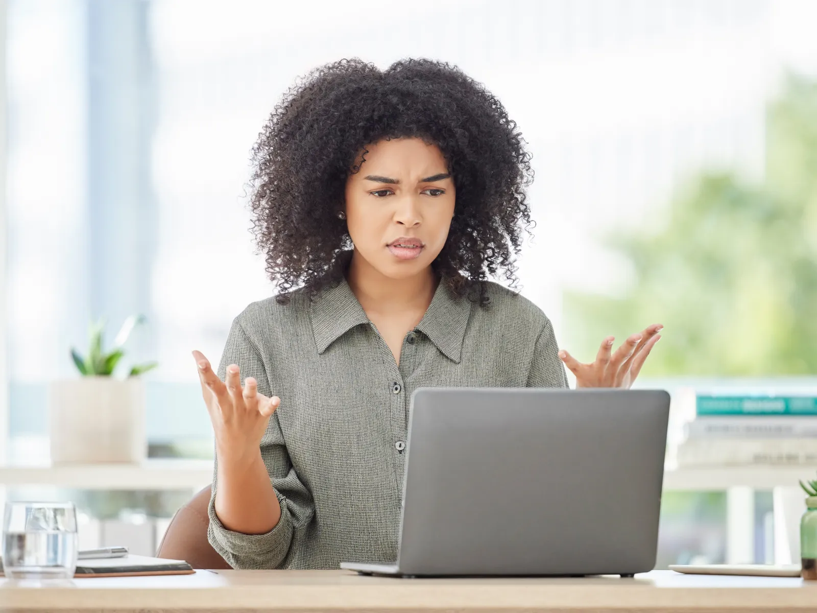 a woman sitting at a table with a laptop
