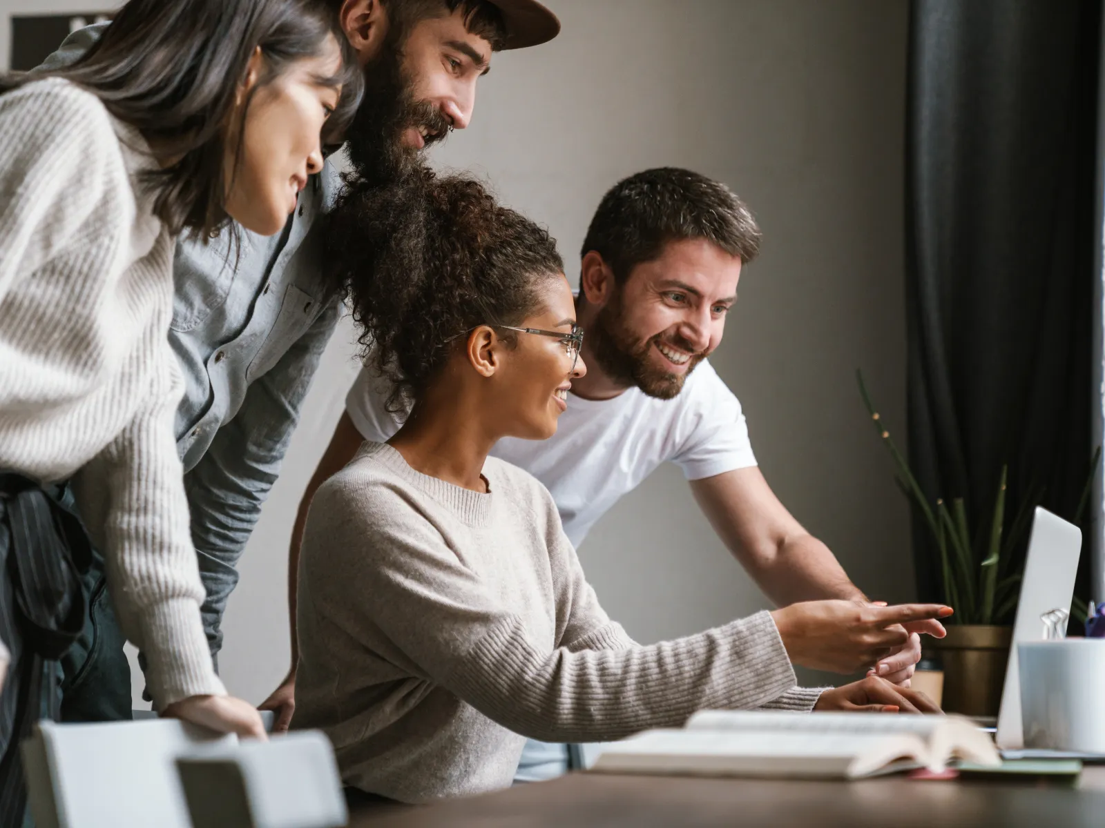 a group of people looking at a computer