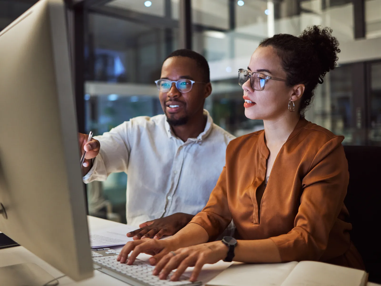 a man and a woman looking at a laptop