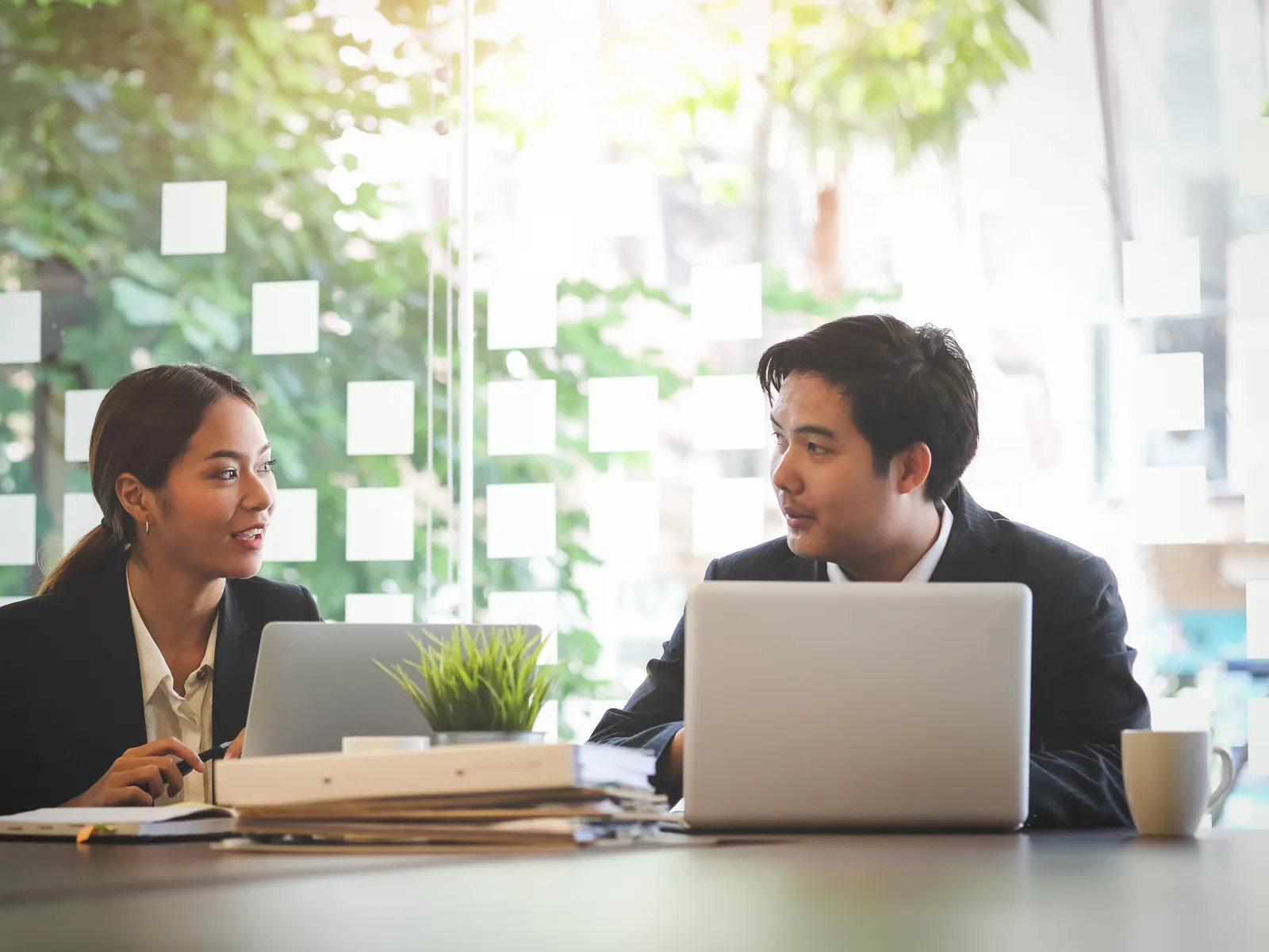 a man and a woman looking at a laptop