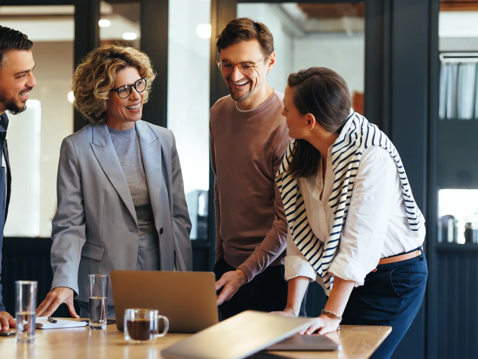 a group of people standing around a table