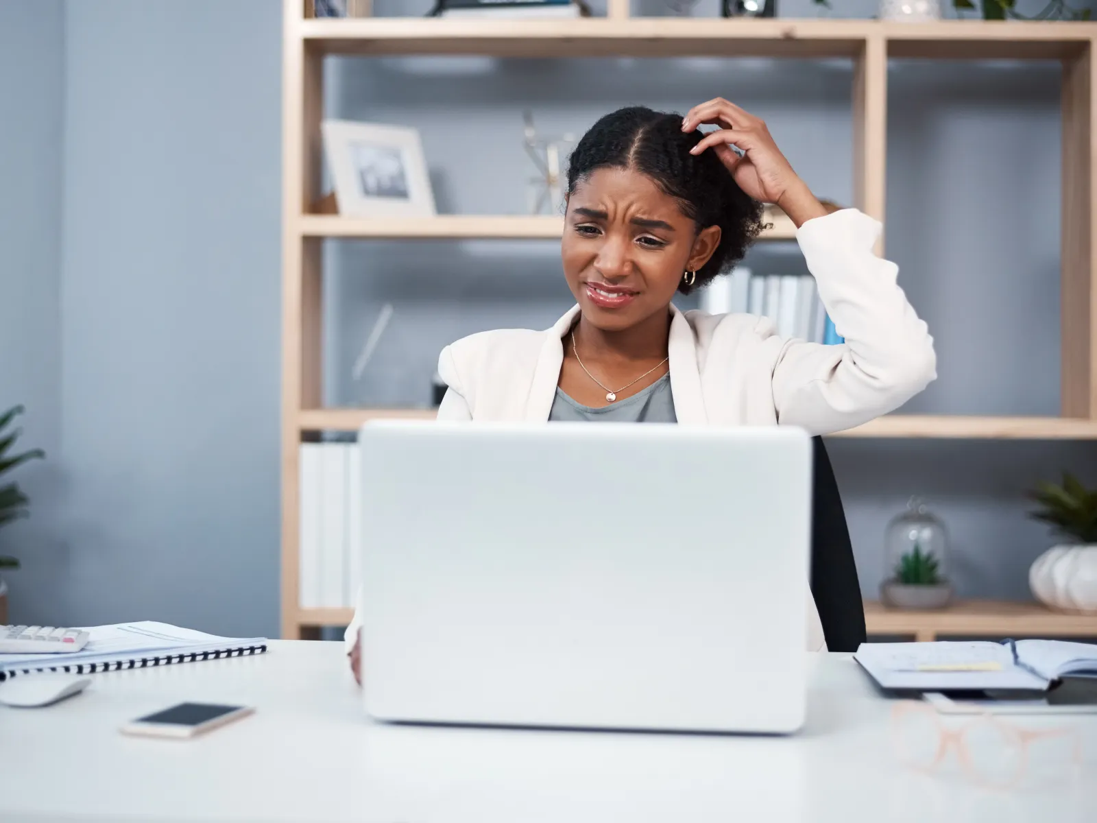 a person sitting at a desk with a laptop