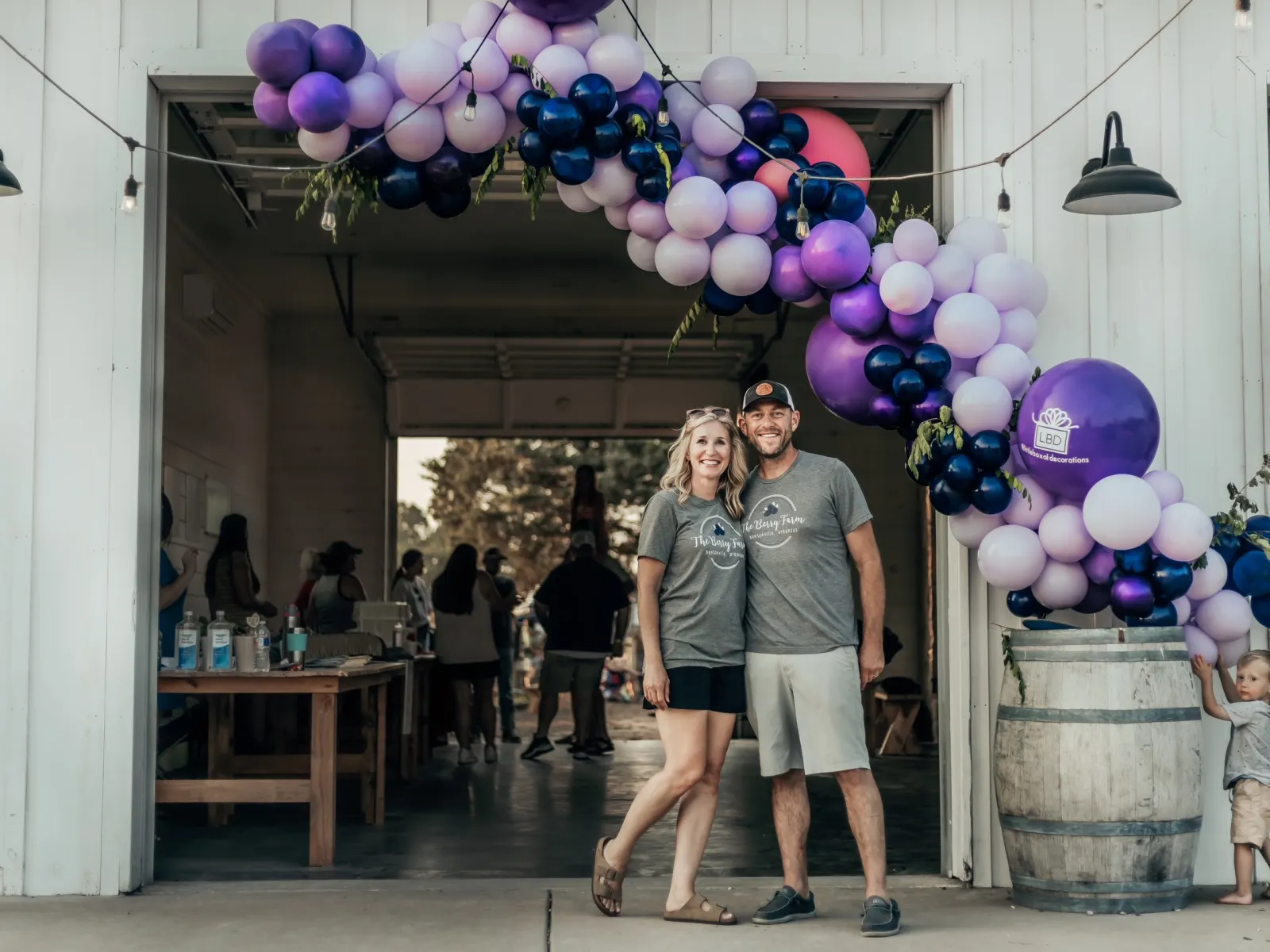 a man and woman standing in front of a large balloon display