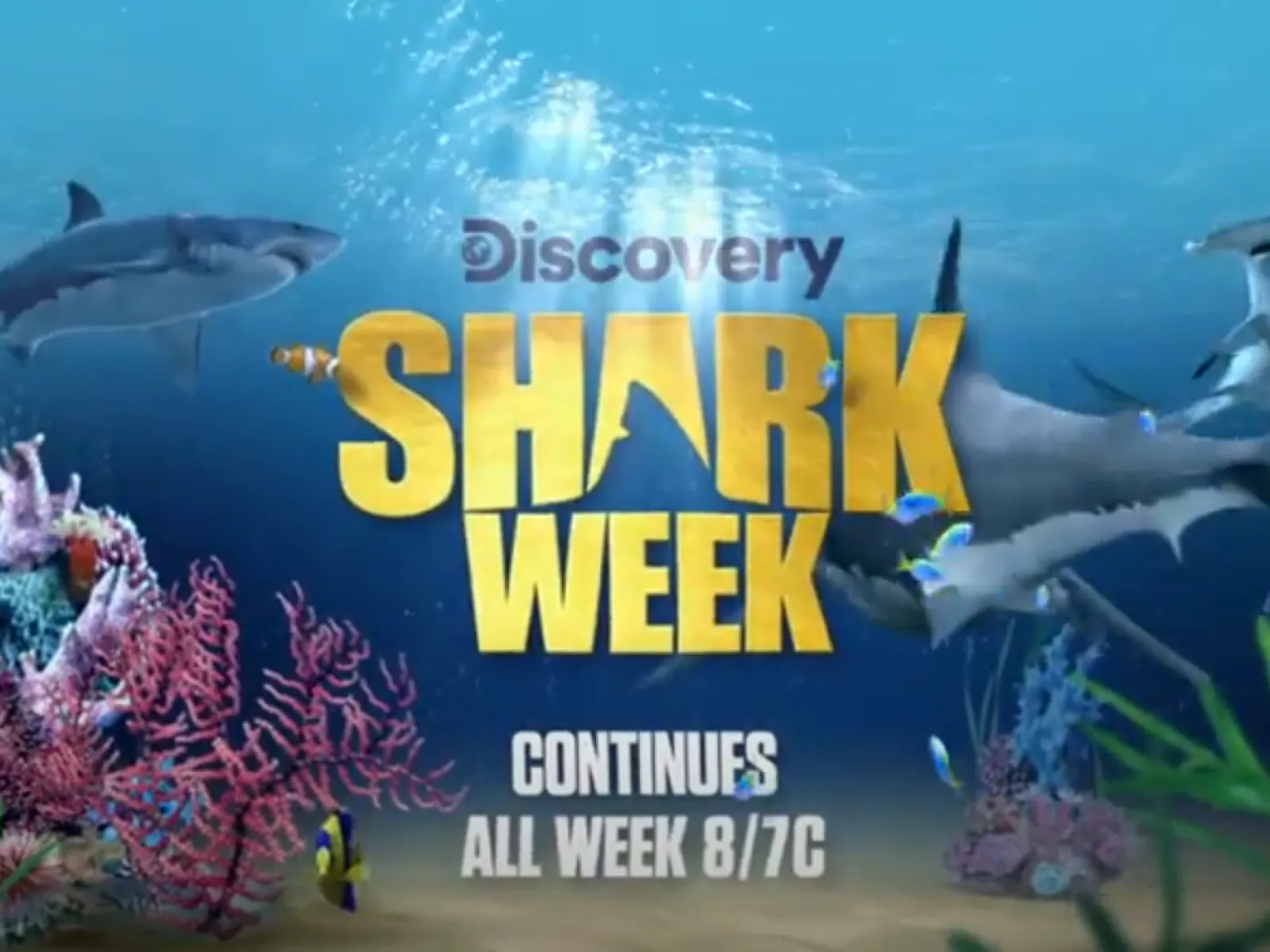 Underwater scene with sharks, colorful coral reefs, and Discovery Shark Week logo with airing details.