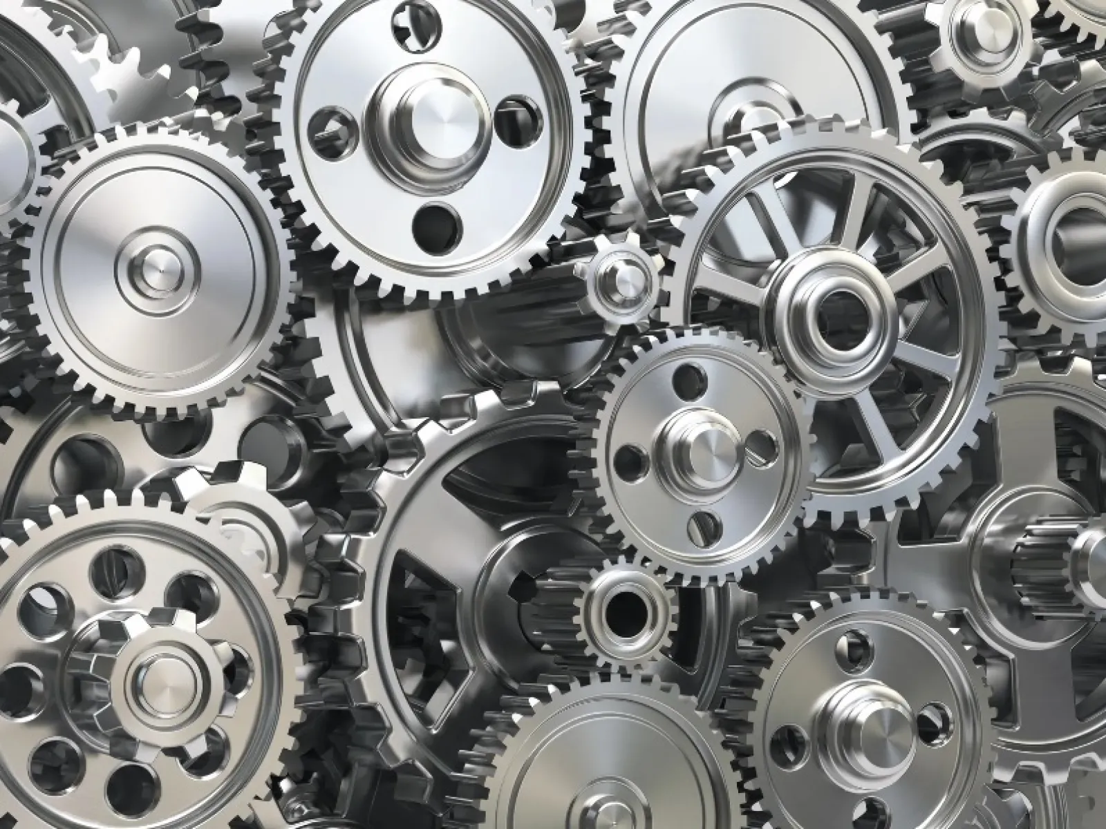 Close-up of interconnected shiny metallic gears in a complex mechanical system showing precision engineering.